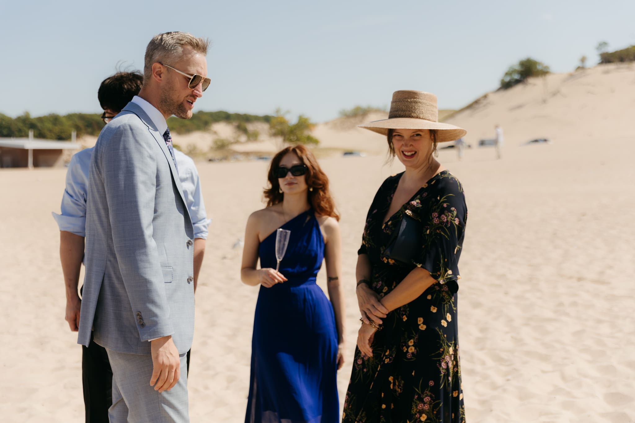Wedding guests mingling during a beach elopement at Warren Dunes State Park