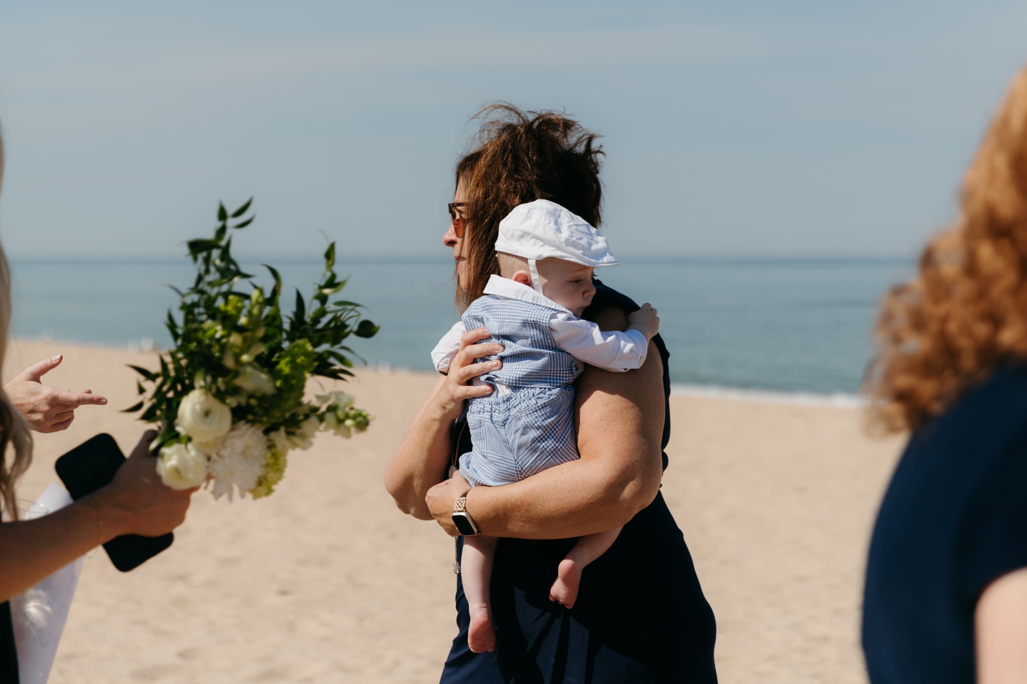 Wedding guests mingling during a beach elopement at Warren Dunes State Park