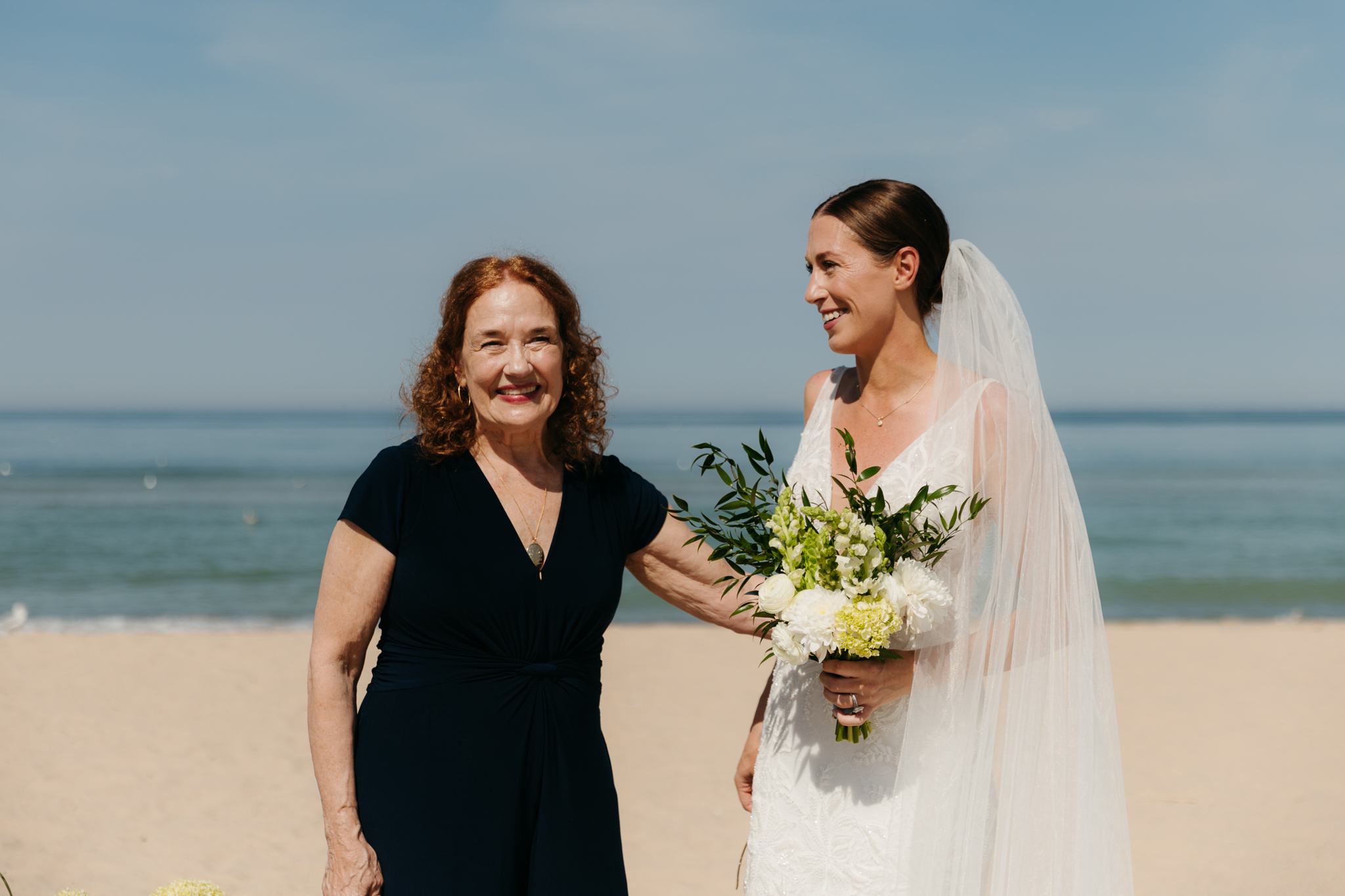 Bride and groom pose with family and friends during their Warren Dunes beach elopement along Lake Michigan