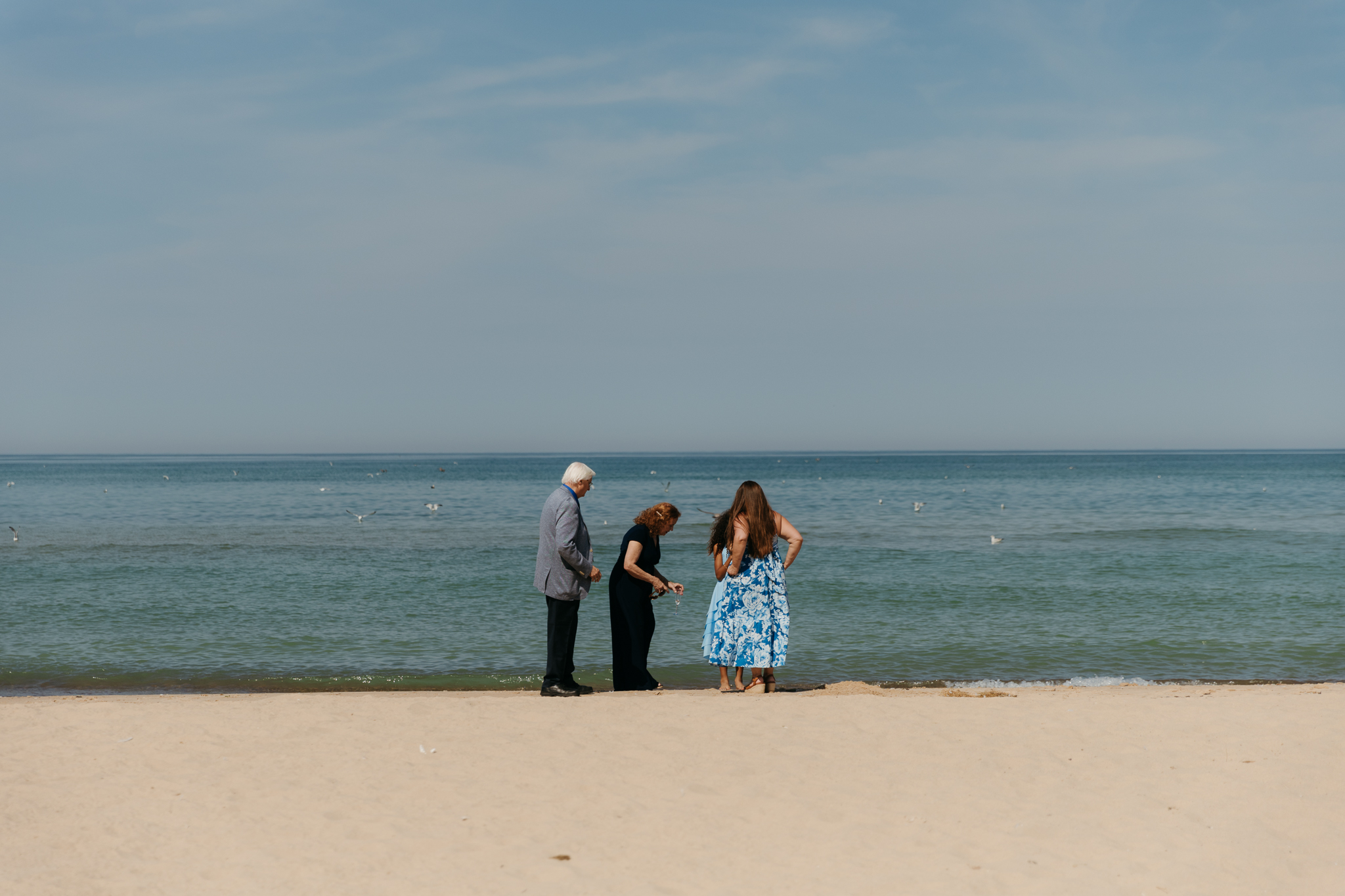 Wedding guests mingling during a beach elopement at Warren Dunes State Park