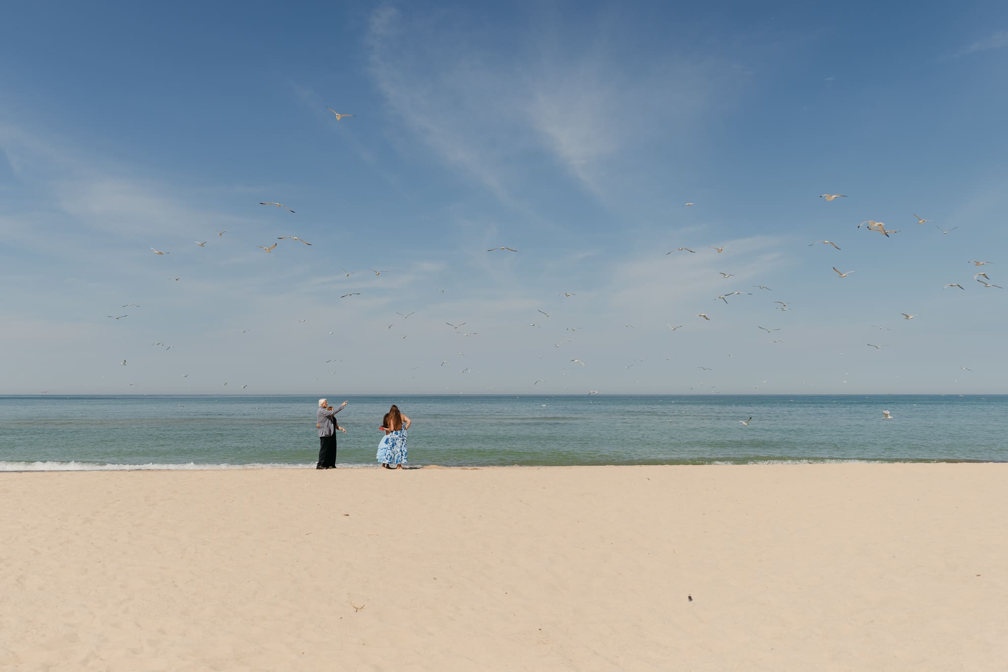 Wedding guests mingling during a beach elopement at Warren Dunes State Park
