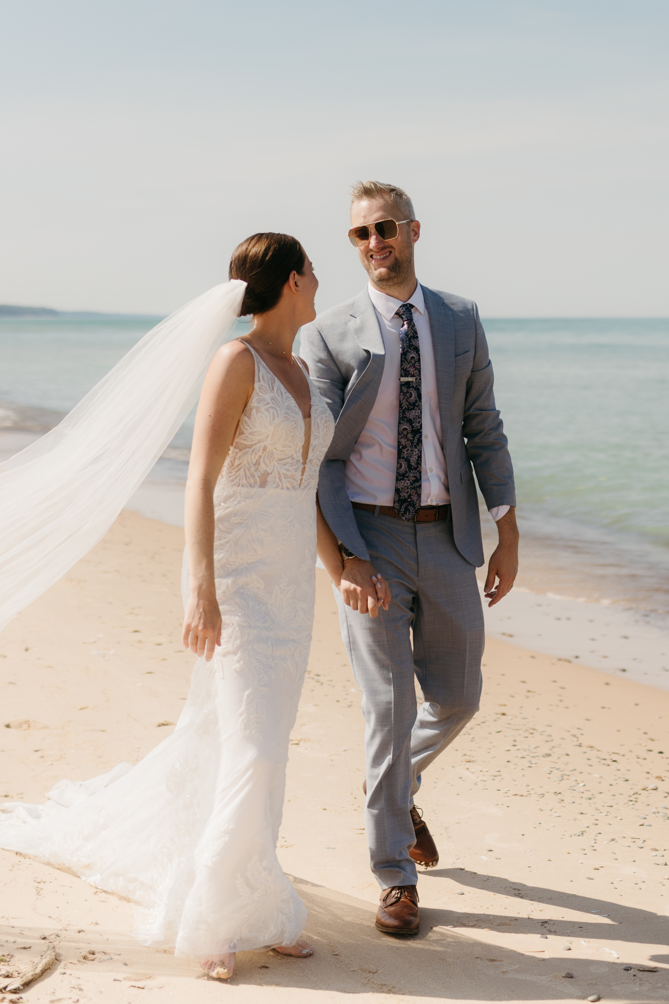 Bride and groom embracing and enjoying their Warren Dunes State Park elopement along the beach