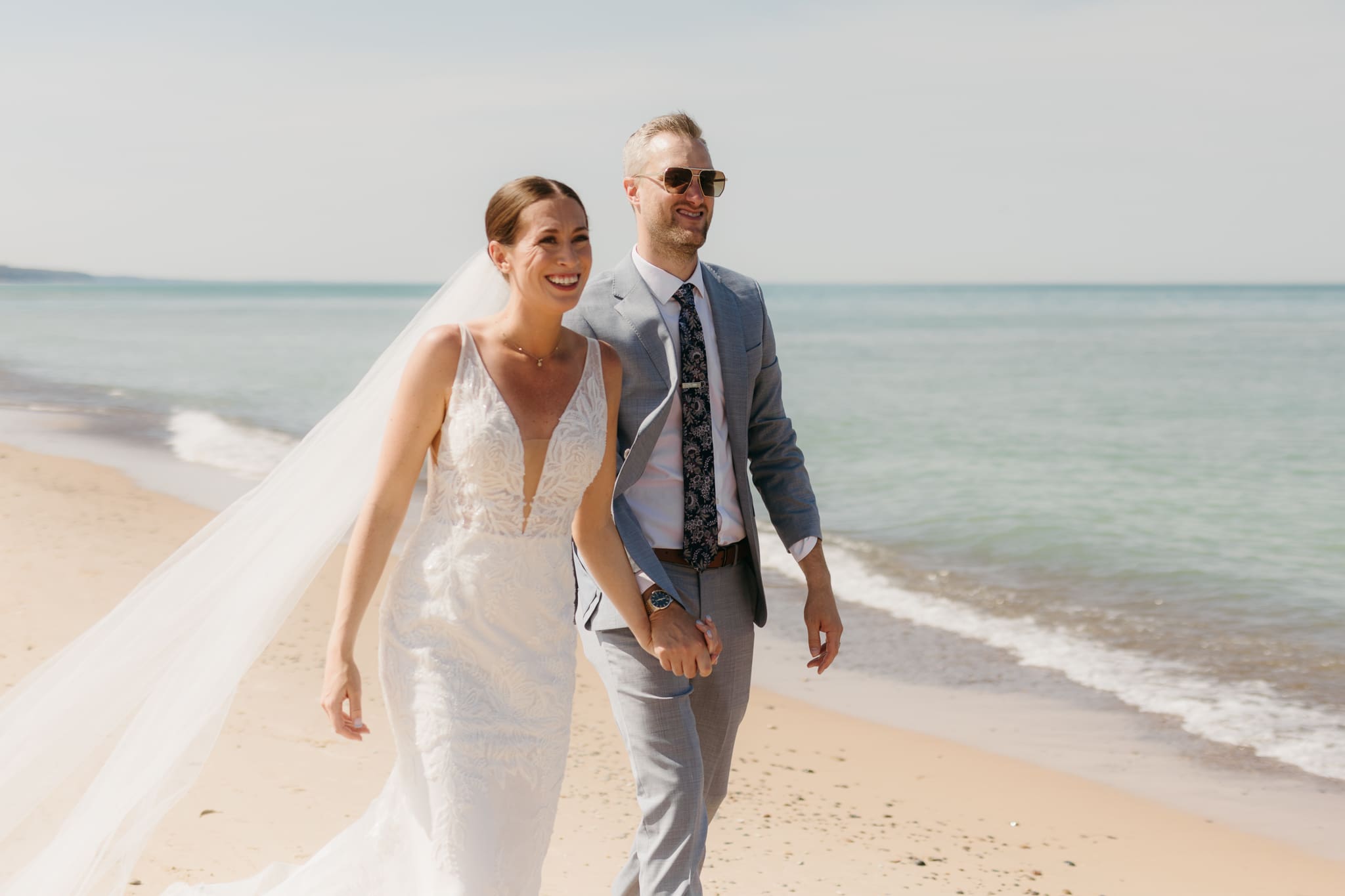 Bride and groom embracing and enjoying their Warren Dunes State Park elopement along the beach