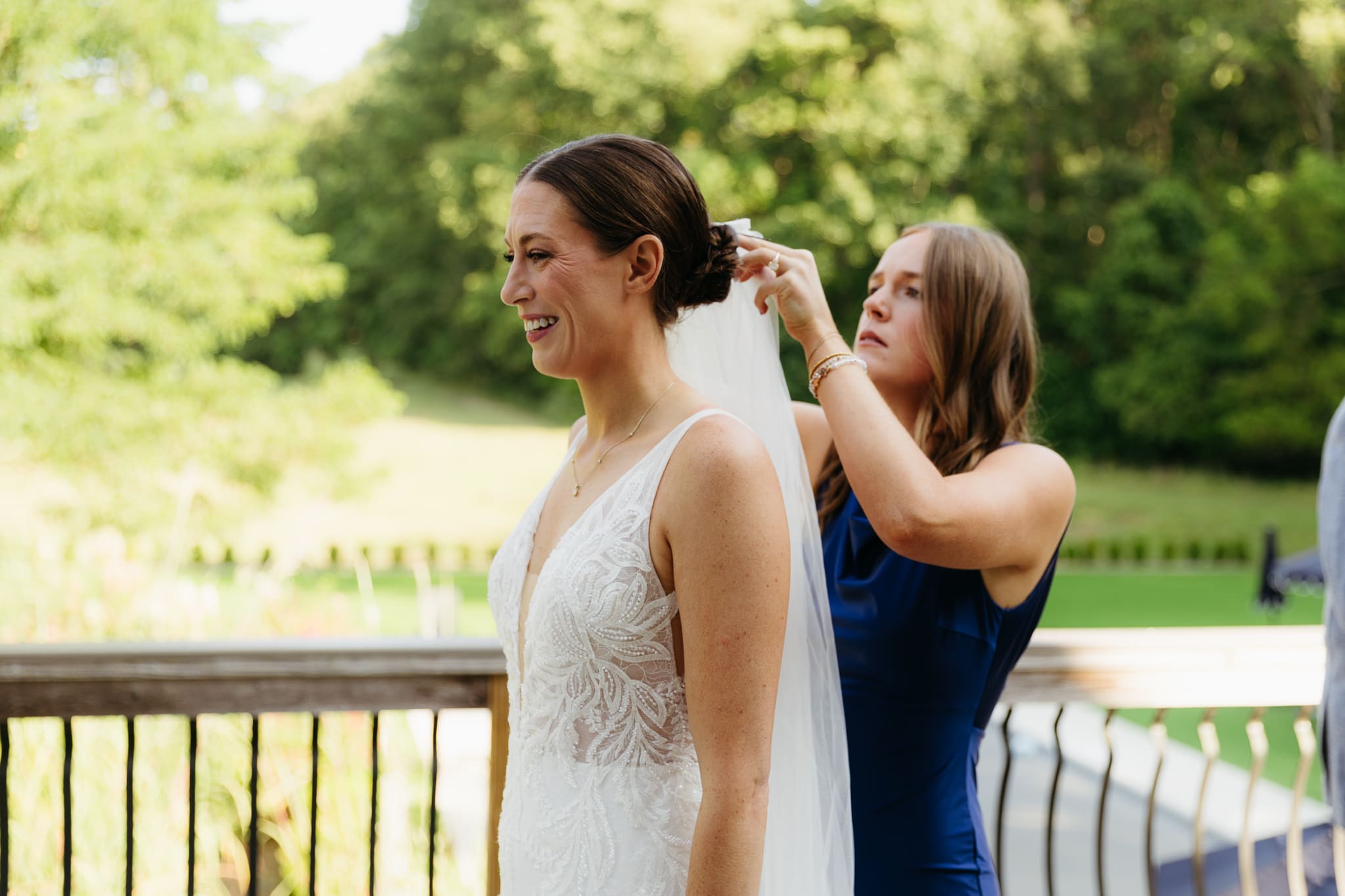 A friend touches up a bride's hair for her Warren Dunes Beach Elopement
