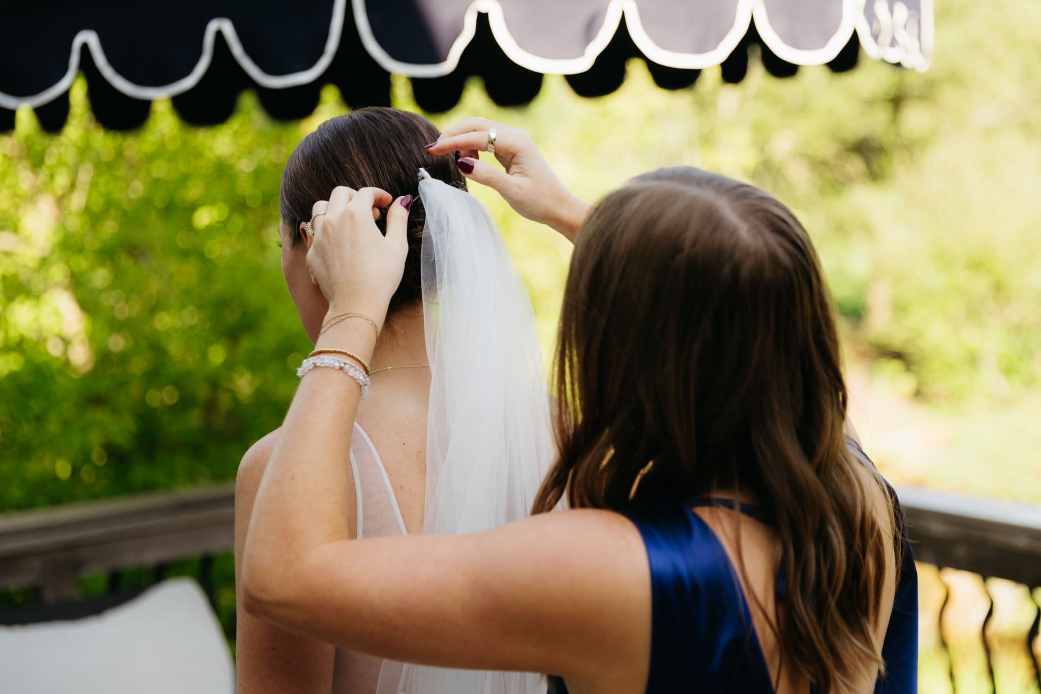 A friend touches up a bride's hair for her Warren Dunes Beach Elopement