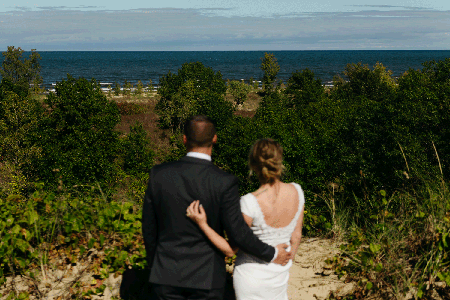 Bride and groom explore the dunes of Indiana Dunes National park during their intimate beach wedding