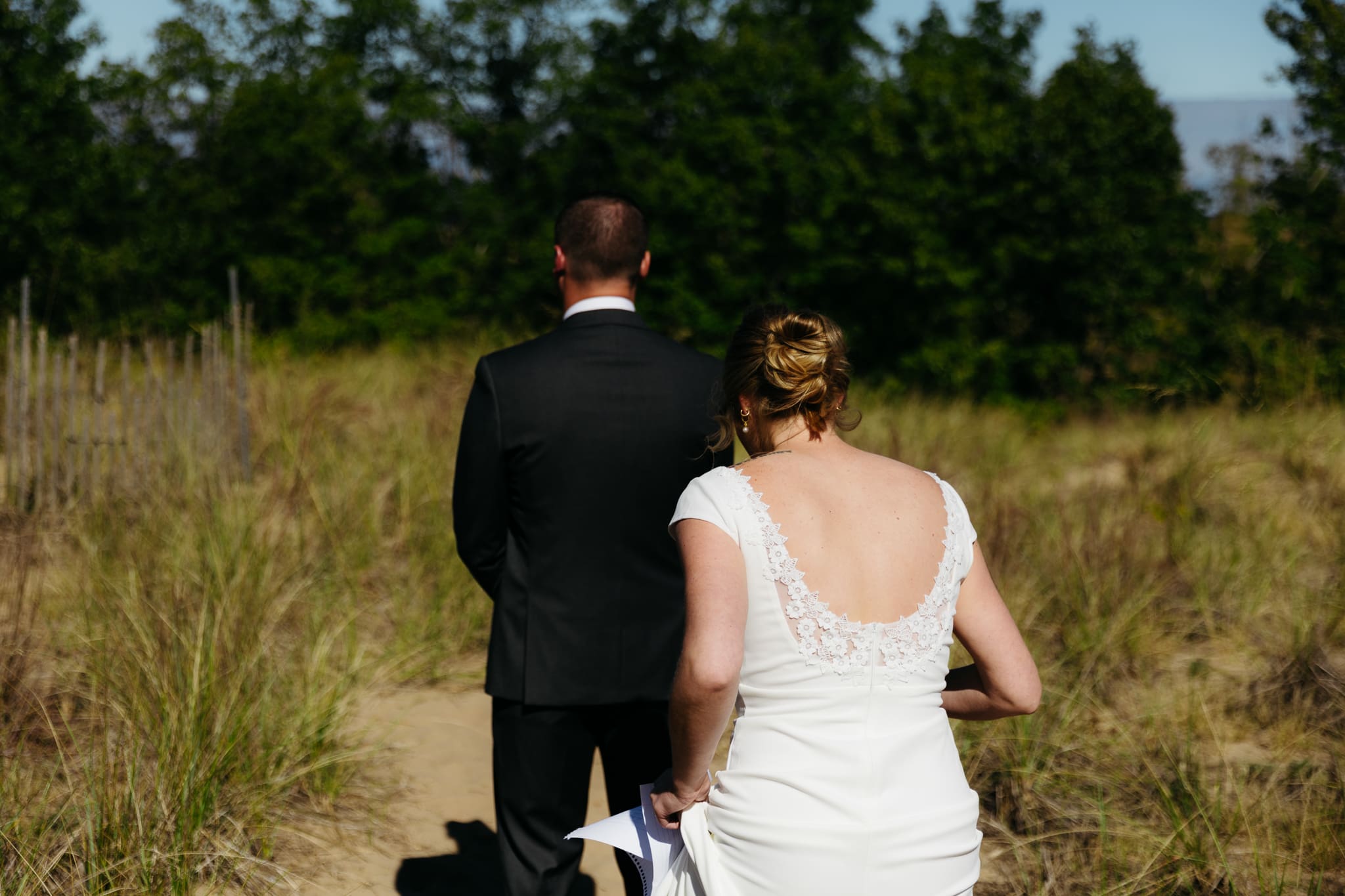 Bride and groom share a first look during their intimate wedding at Indiana Dunes National Park, amongst the sand dunes.