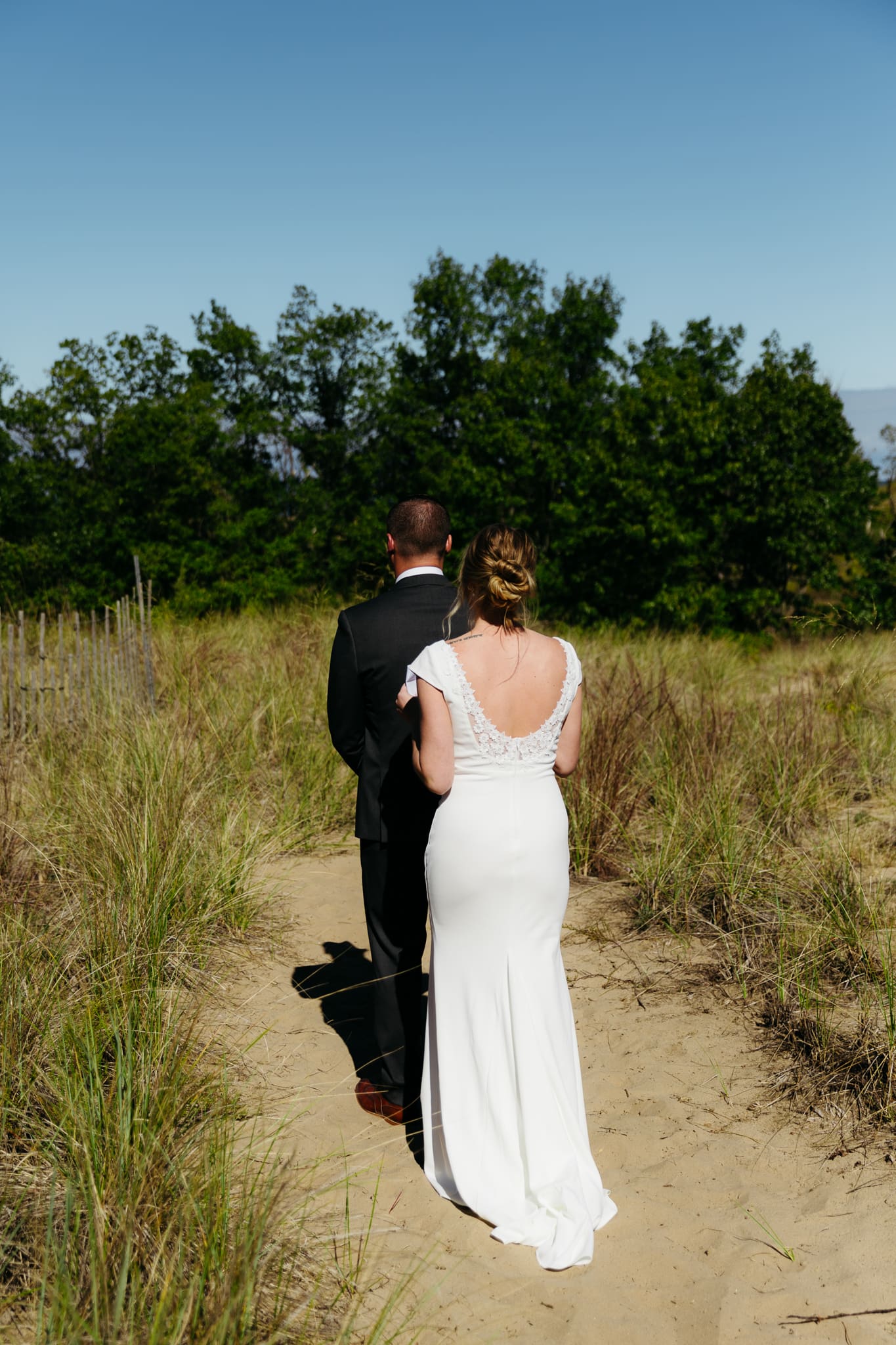 Bride and groom share a first look during their intimate wedding at Indiana Dunes National Park, amongst the sand dunes.