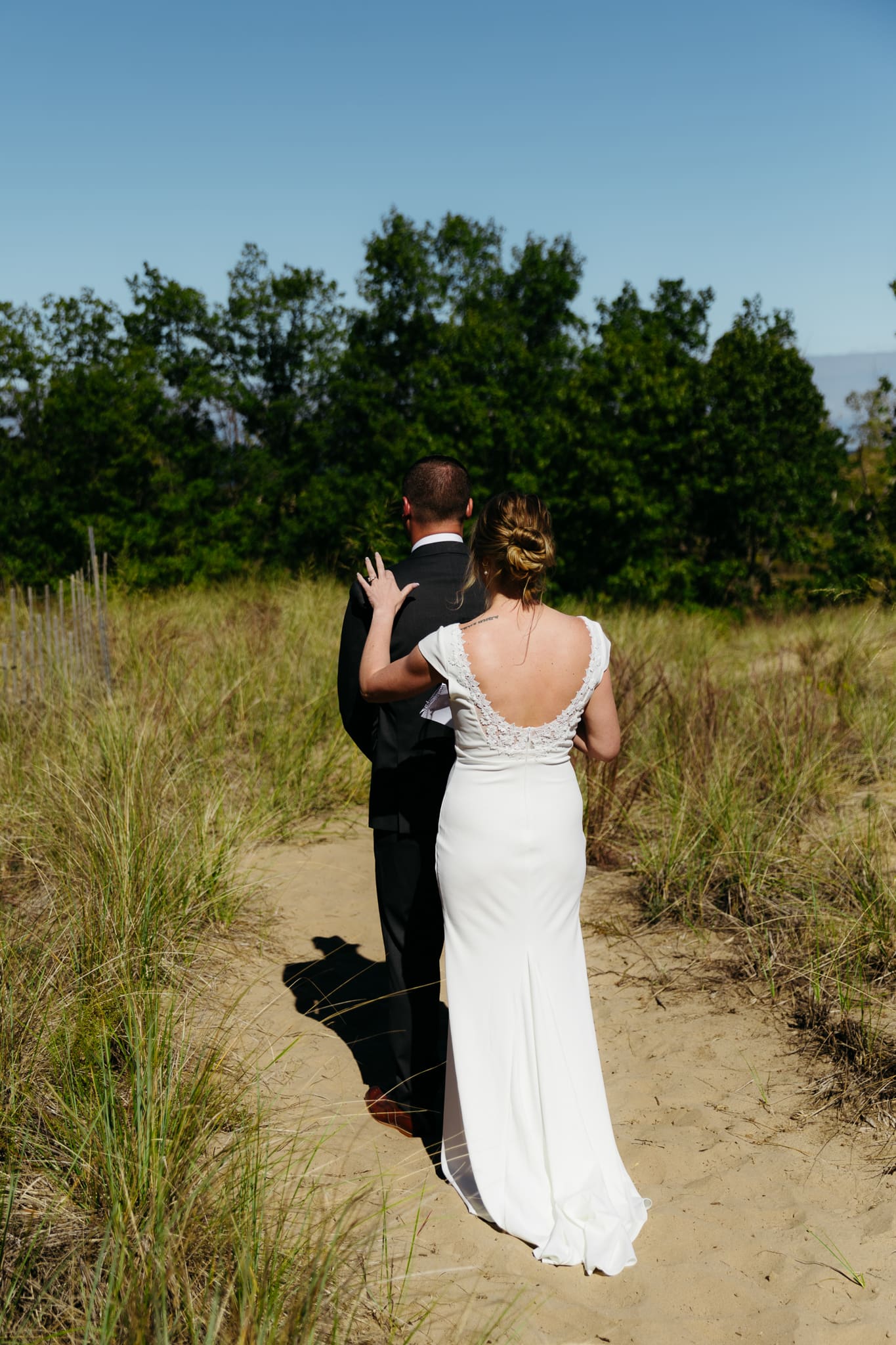 Bride and groom share a first look during their intimate wedding at Indiana Dunes National Park, amongst the sand dunes.