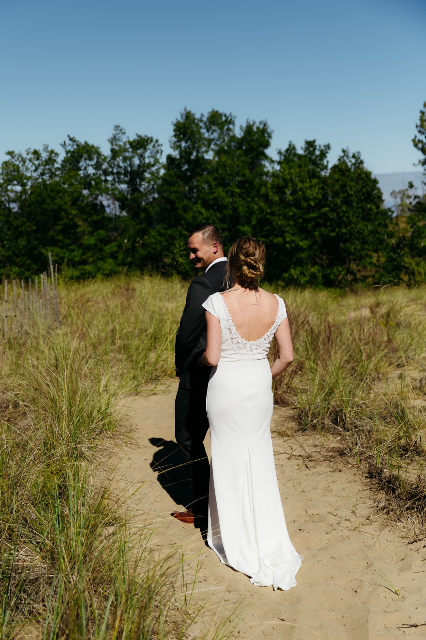 Bride and groom share a first look during their intimate wedding at Indiana Dunes National Park, amongst the sand dunes.
