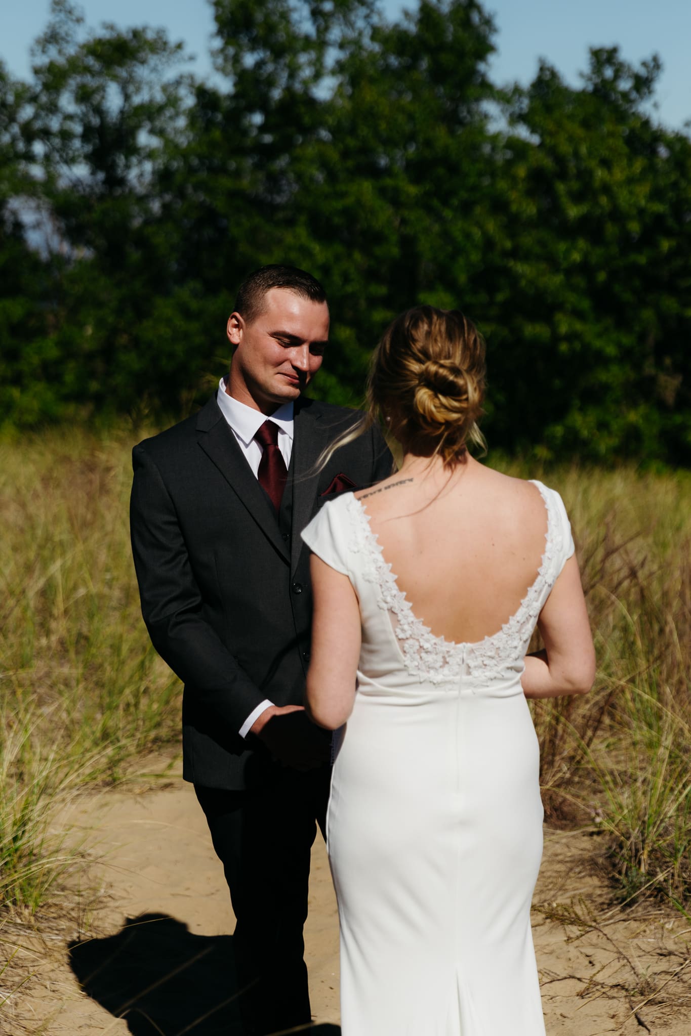 Bride and groom share a first look during their intimate wedding at Indiana Dunes National Park, amongst the sand dunes.