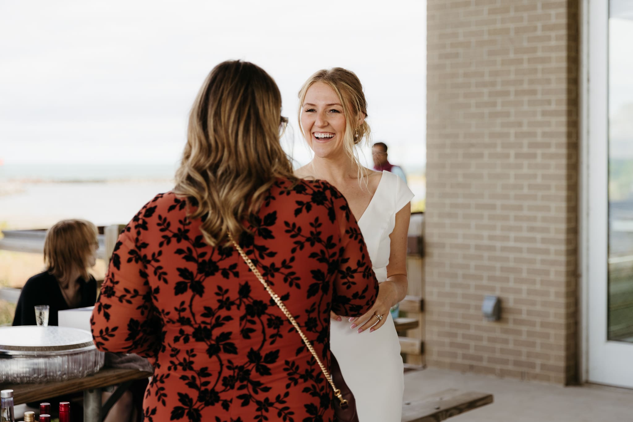 Bride and groom hanging out with family and friends during their outdoor wedding at Indiana Dunes National Park