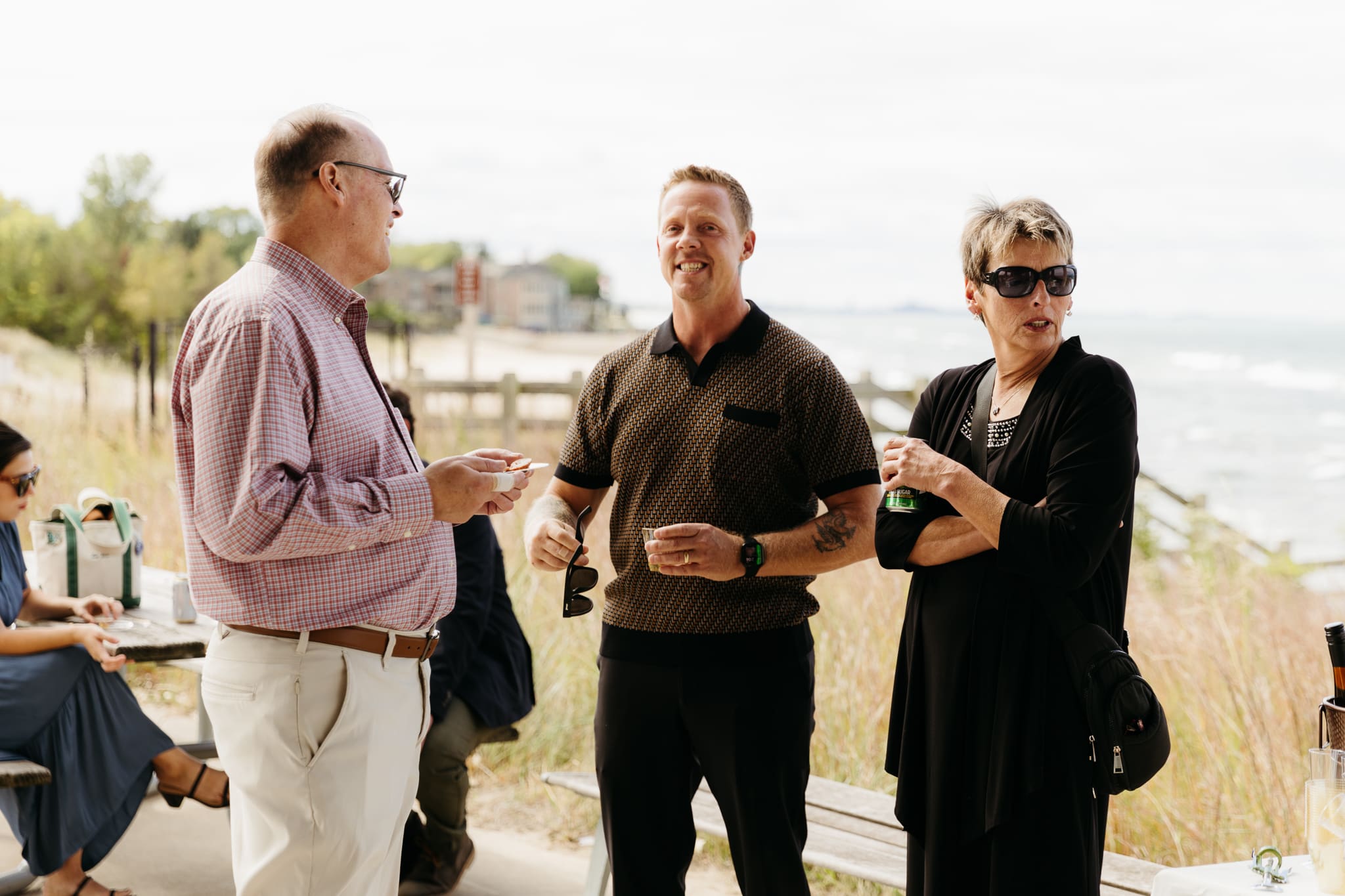 Bride and groom hanging out with family and friends during their outdoor wedding at Indiana Dunes National Park