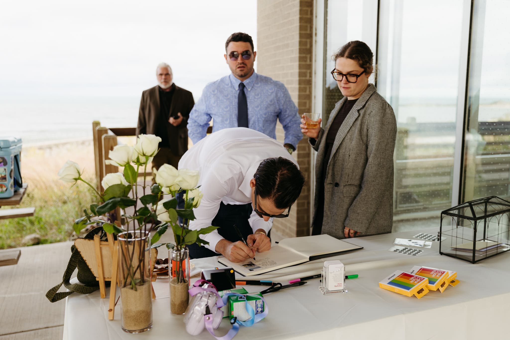 Bride and groom hanging out with family and friends during their outdoor wedding at Indiana Dunes National Park