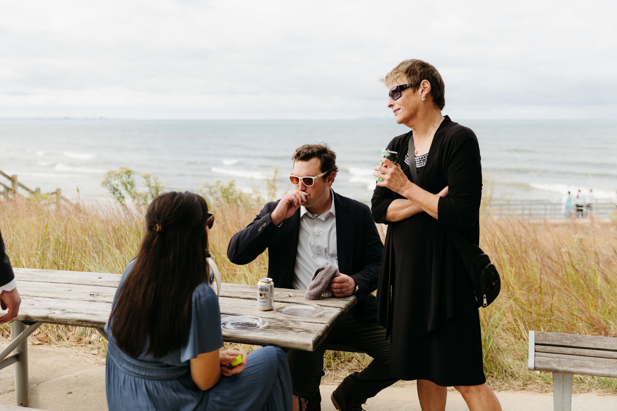 Bride and groom hanging out with family and friends during their outdoor wedding at Indiana Dunes National Park