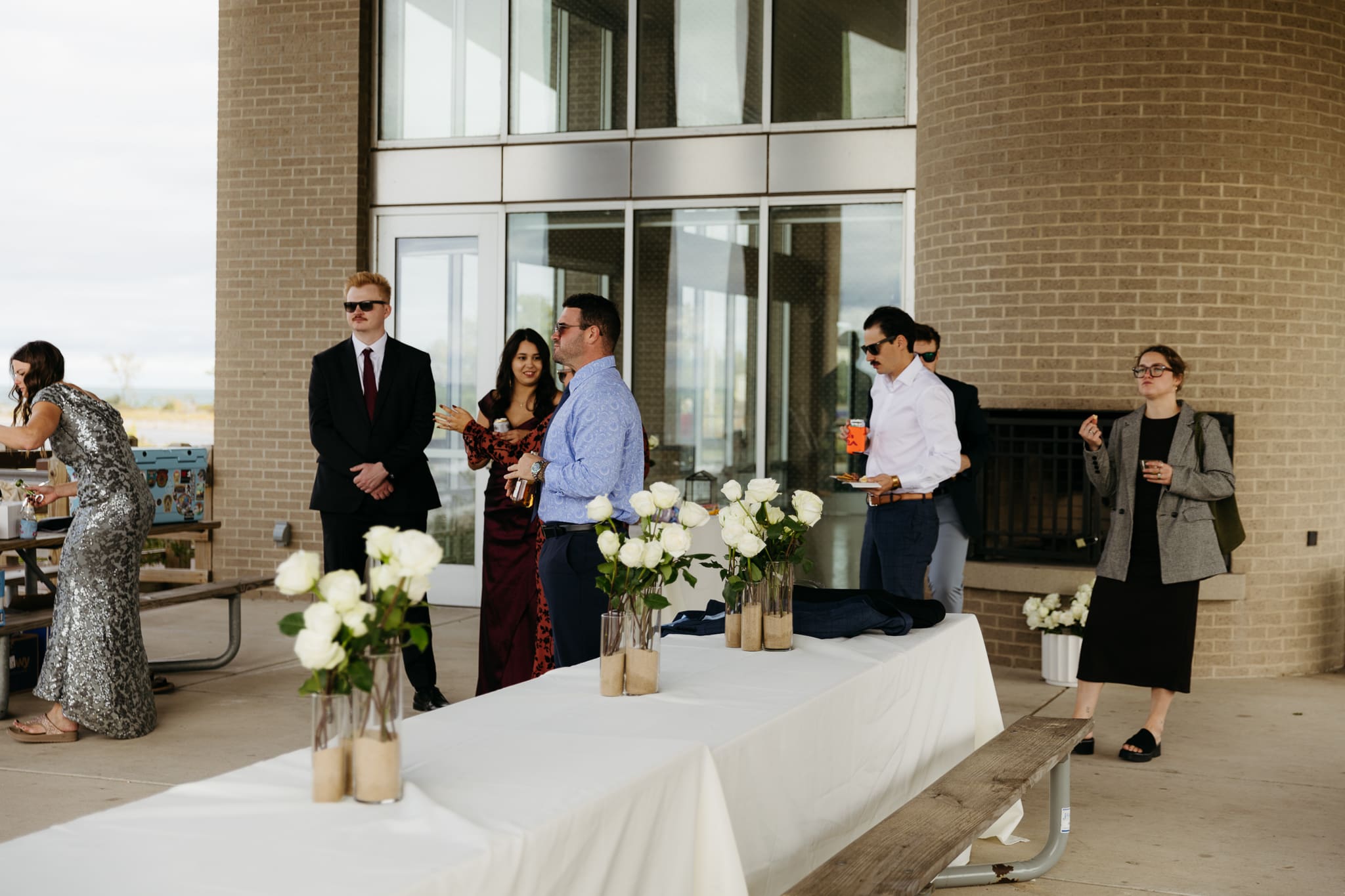 Bride and groom hanging out with family and friends during their outdoor wedding at Indiana Dunes National Park