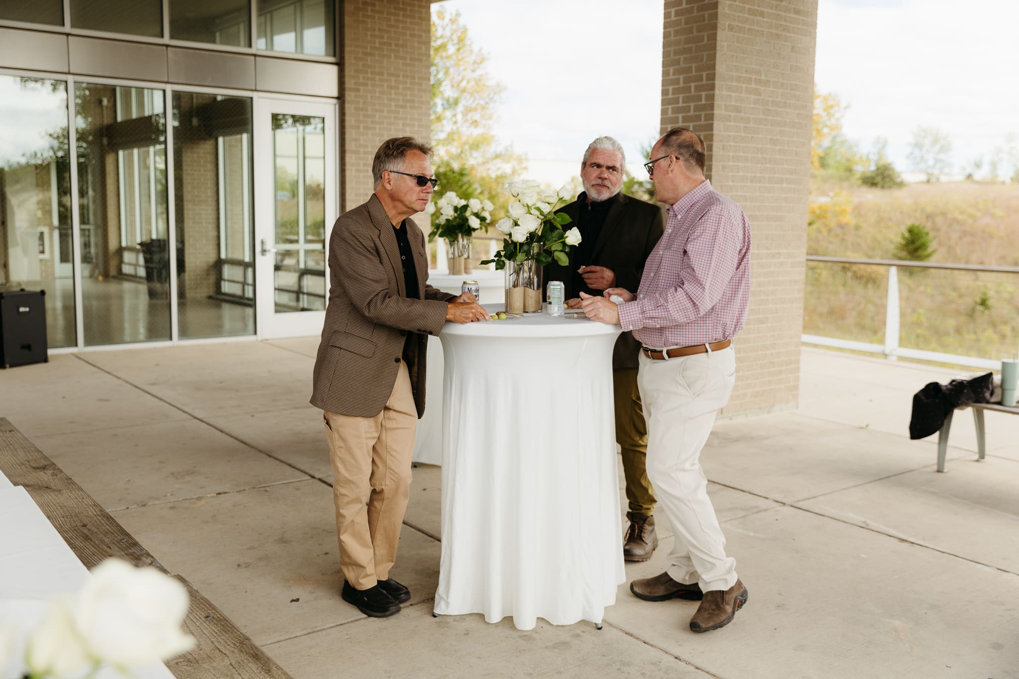 Bride and groom hanging out with family and friends during their outdoor wedding at Indiana Dunes National Park