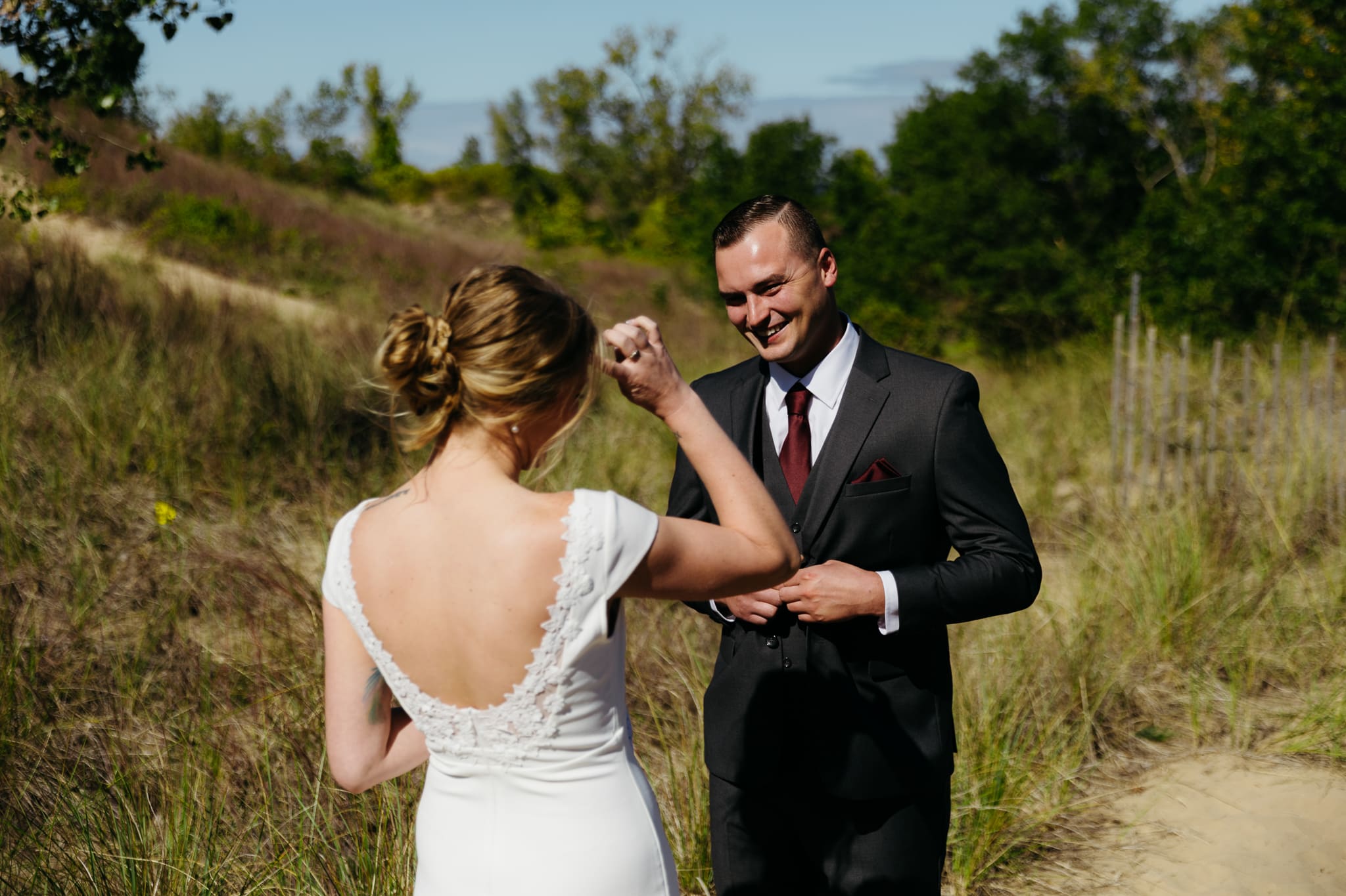 Bride and groom share a first look during their intimate wedding at Indiana Dunes National Park, amongst the sand dunes.