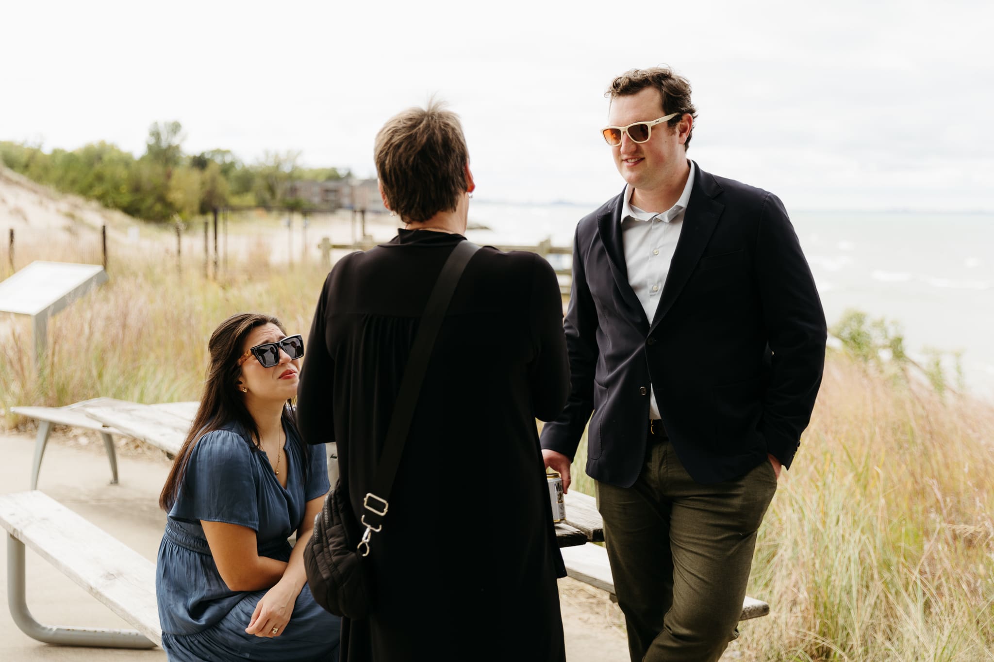 Bride and groom hanging out with family and friends during their outdoor wedding at Indiana Dunes National Park