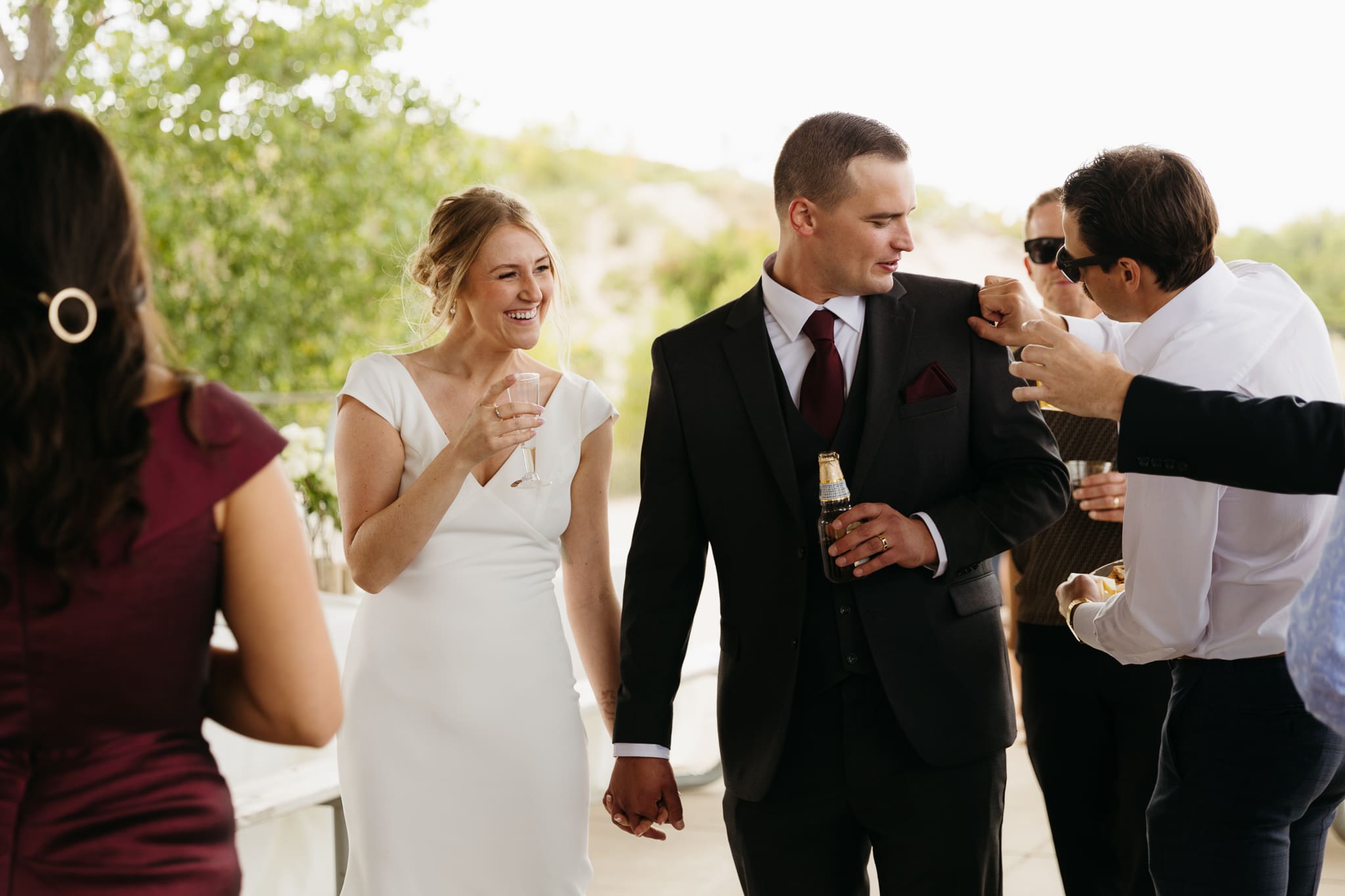 Bride and groom hanging out with family and friends during their outdoor wedding at Indiana Dunes National Park