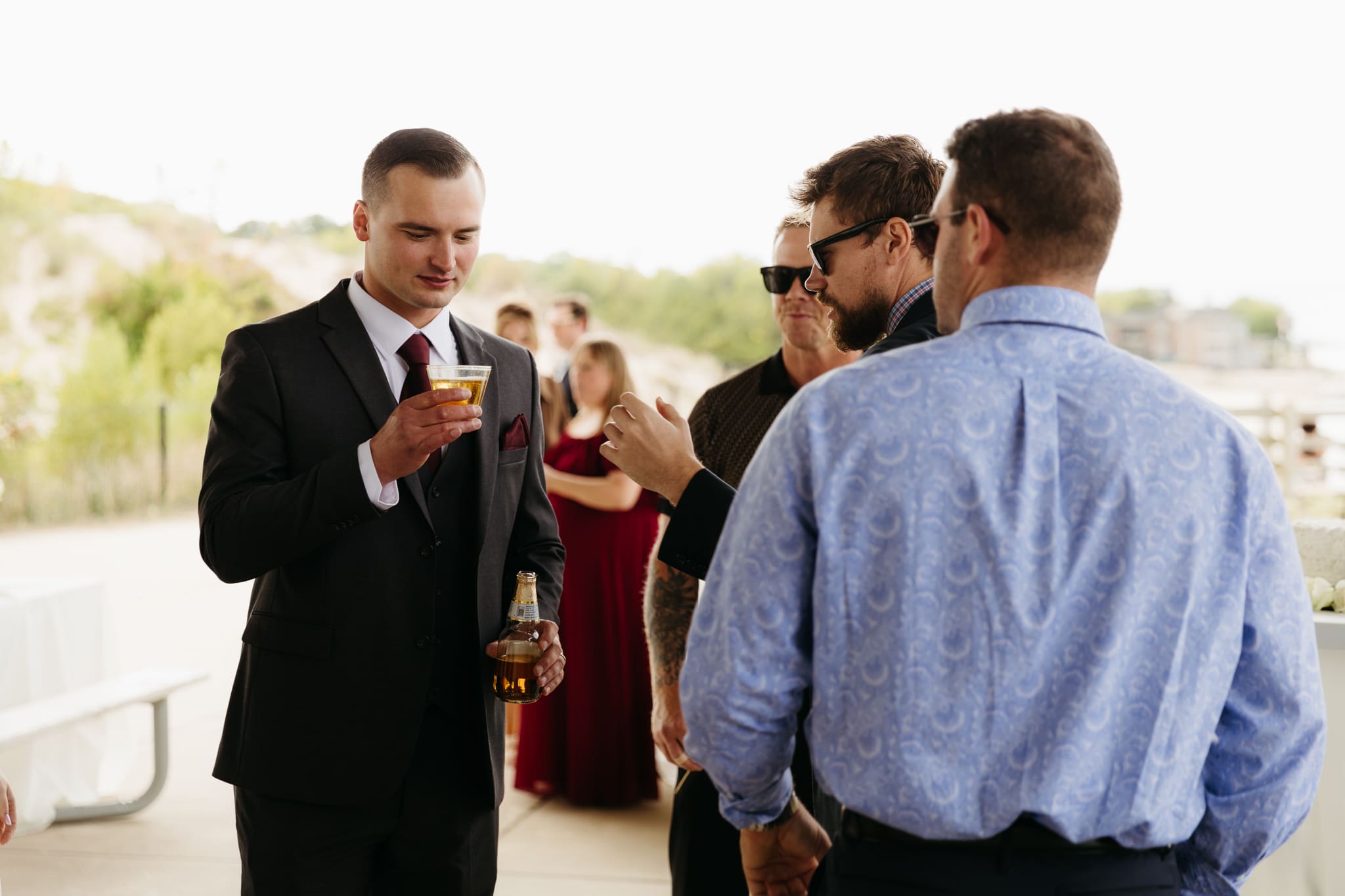 Bride and groom hanging out with family and friends during their outdoor wedding at Indiana Dunes National Park