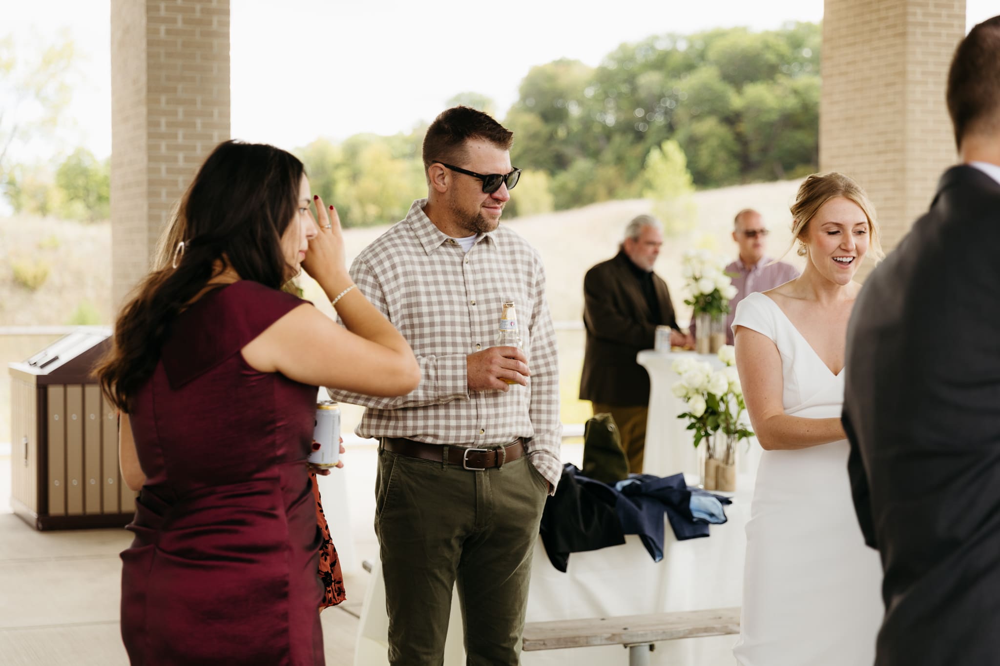 Bride and groom hanging out with family and friends during their outdoor wedding at Indiana Dunes National Park
