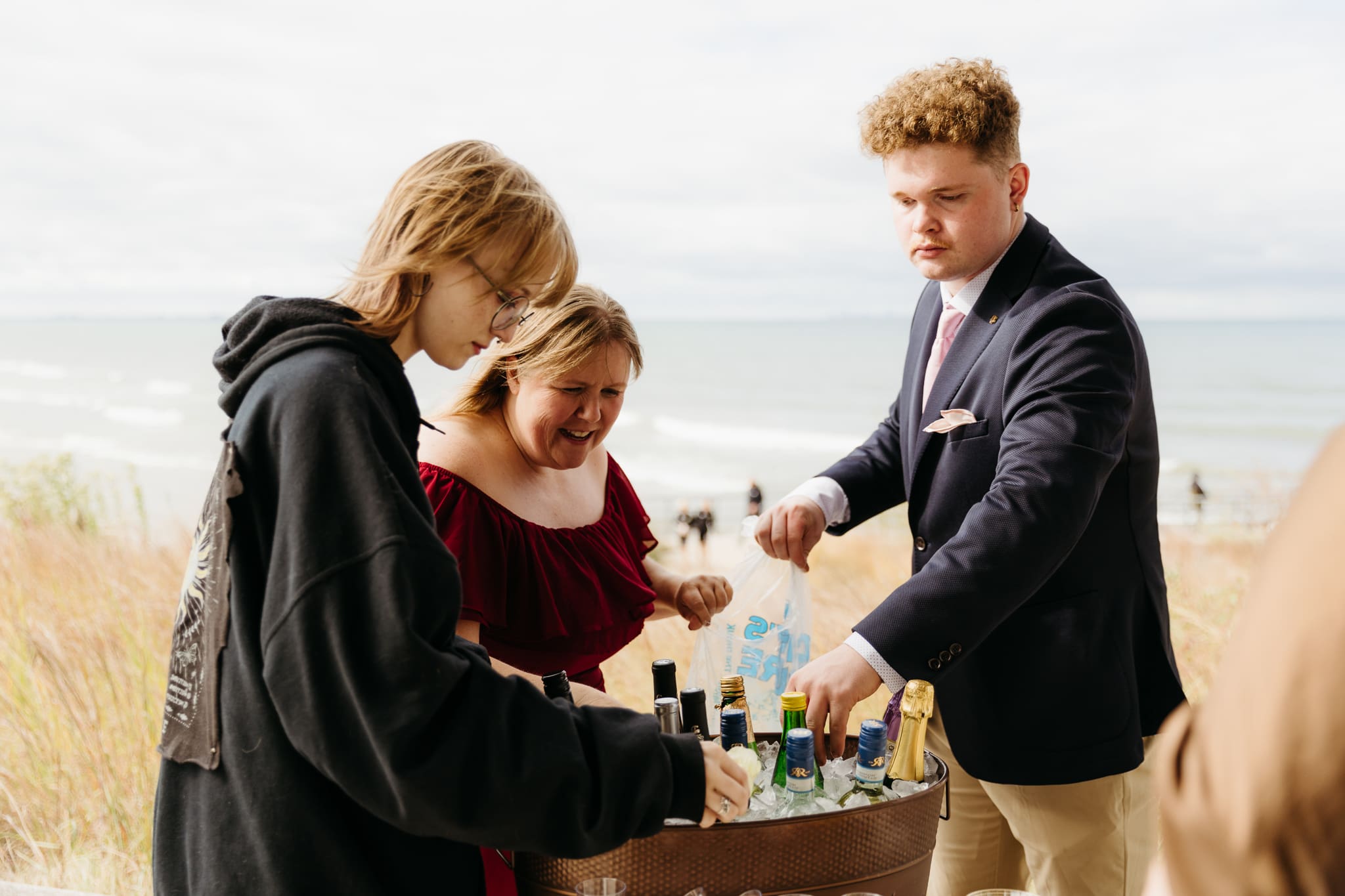 Bride and groom hanging out with family and friends during their outdoor wedding at Indiana Dunes National Park