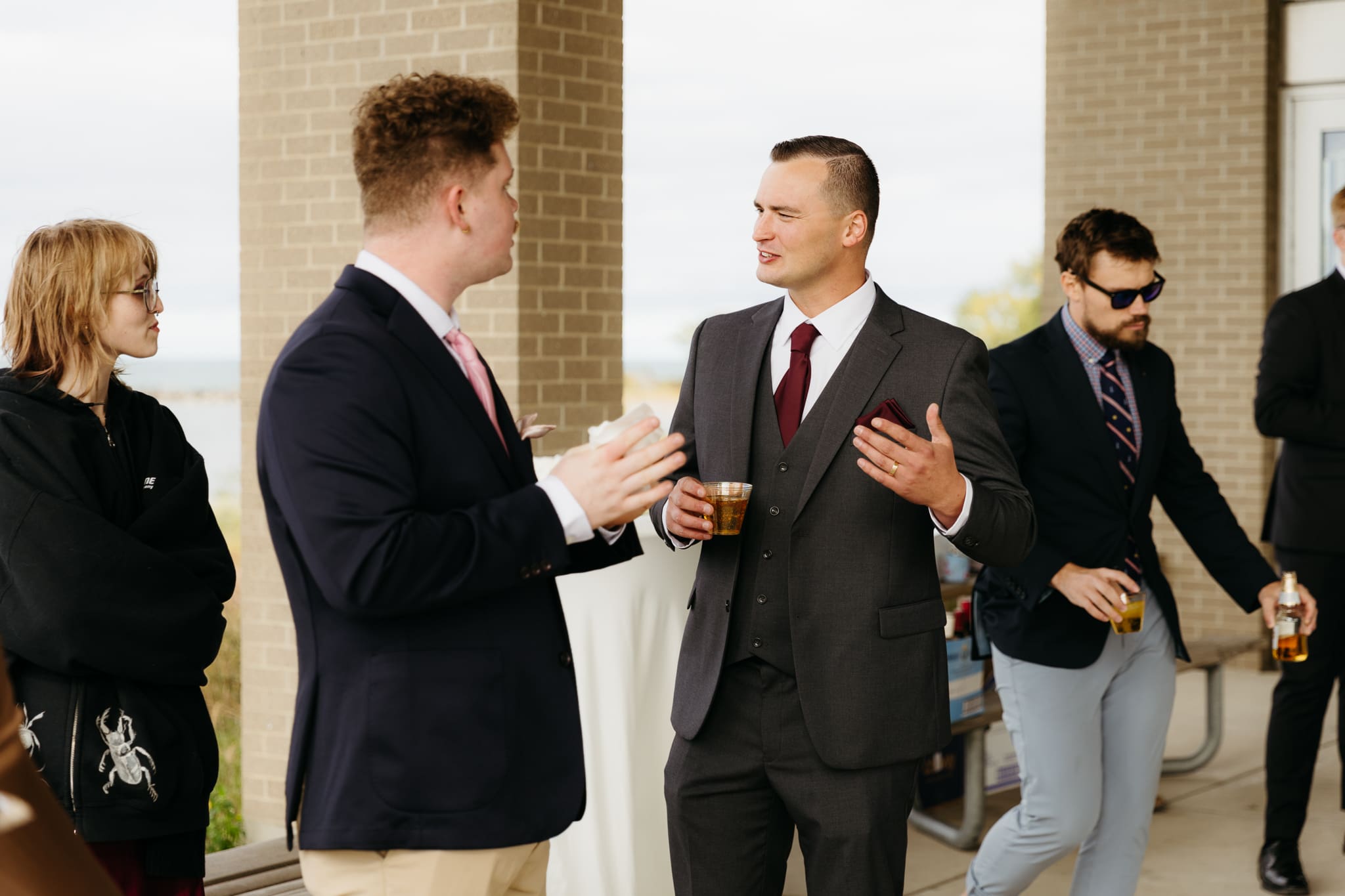 Bride and groom hanging out with family and friends during their outdoor wedding at Indiana Dunes National Park