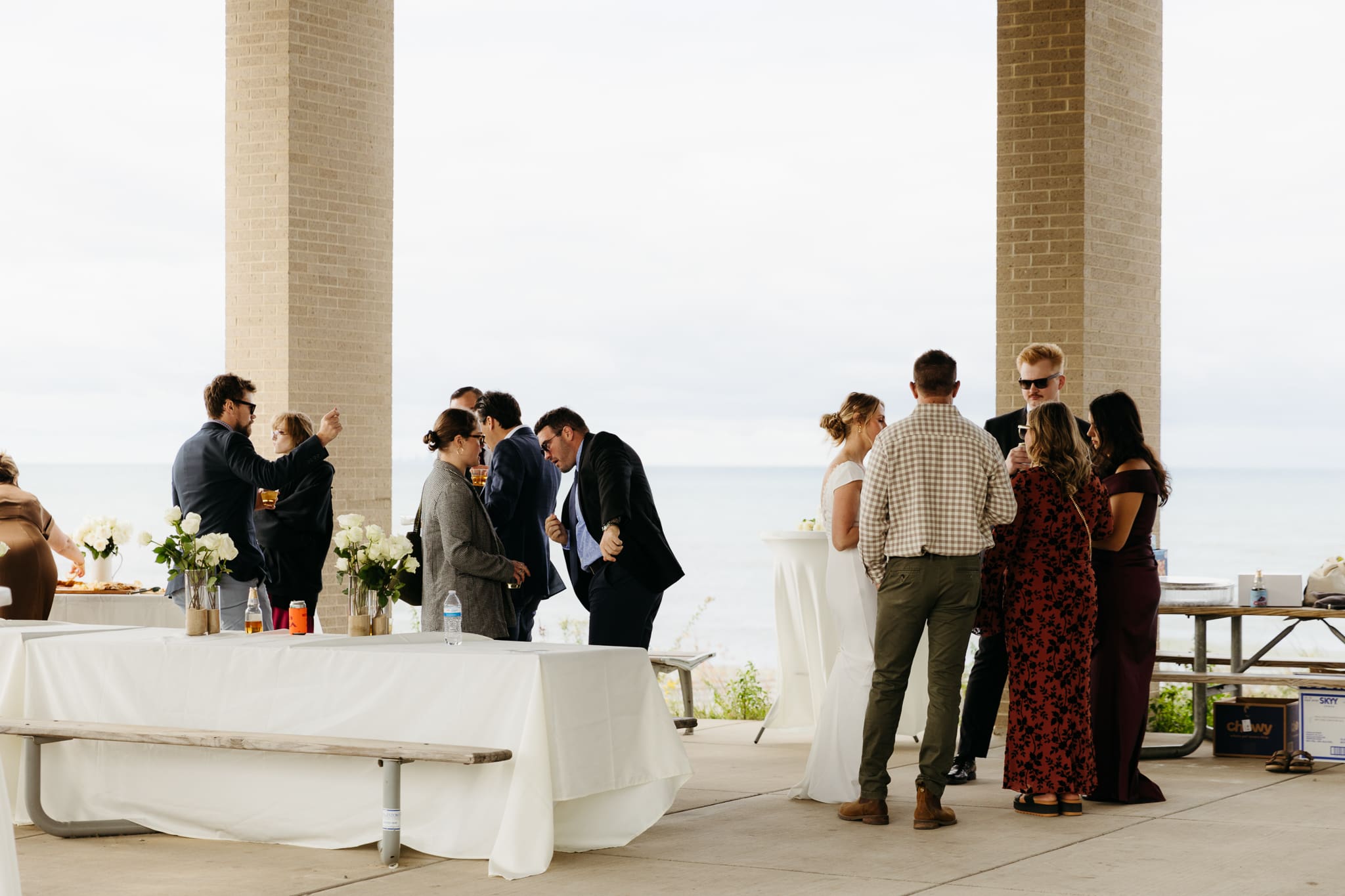 Bride and groom hanging out with family and friends during their outdoor wedding at Indiana Dunes National Park