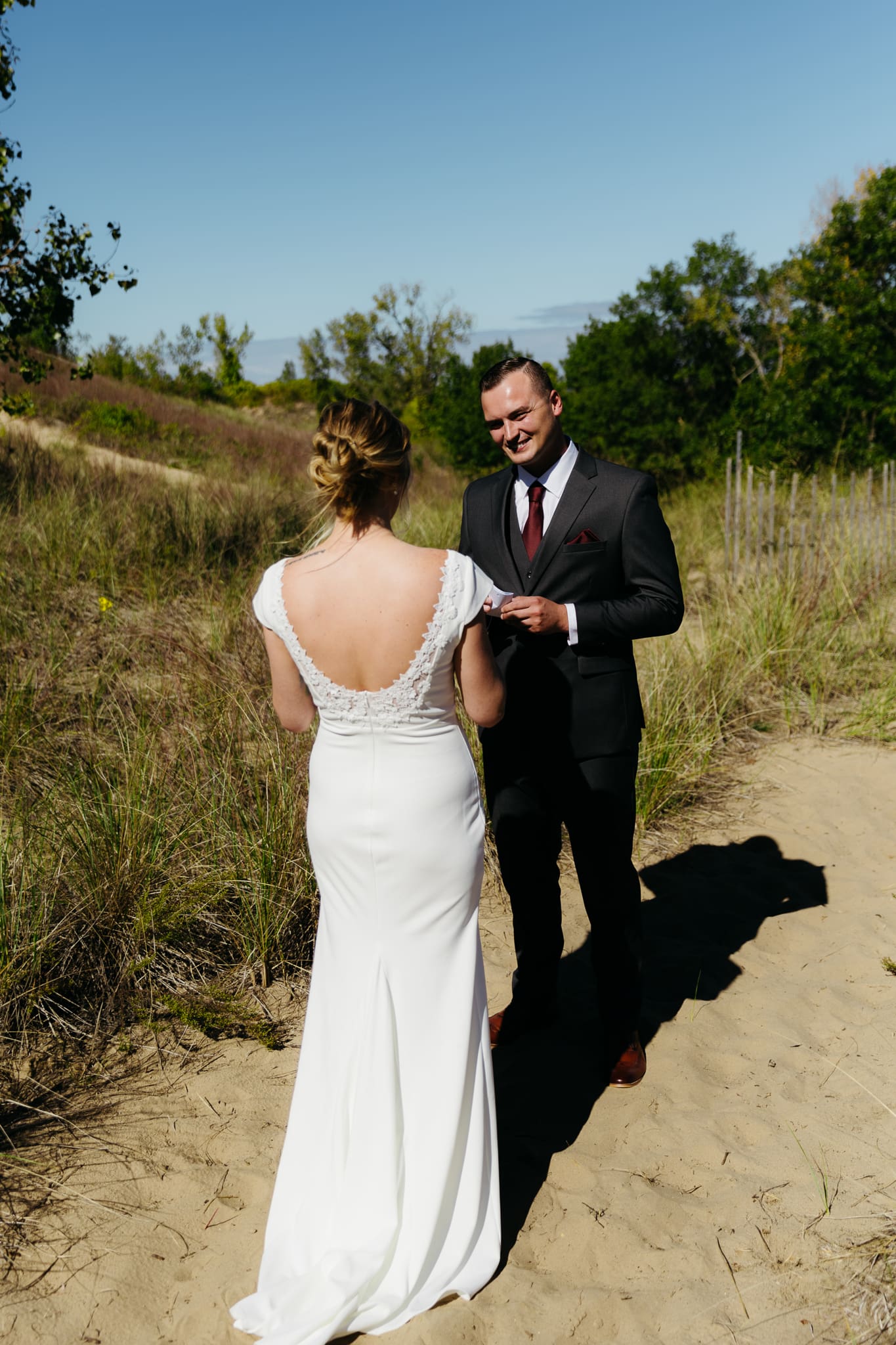 Bride and groom share a first look during their intimate wedding at Indiana Dunes National Park, amongst the sand dunes.