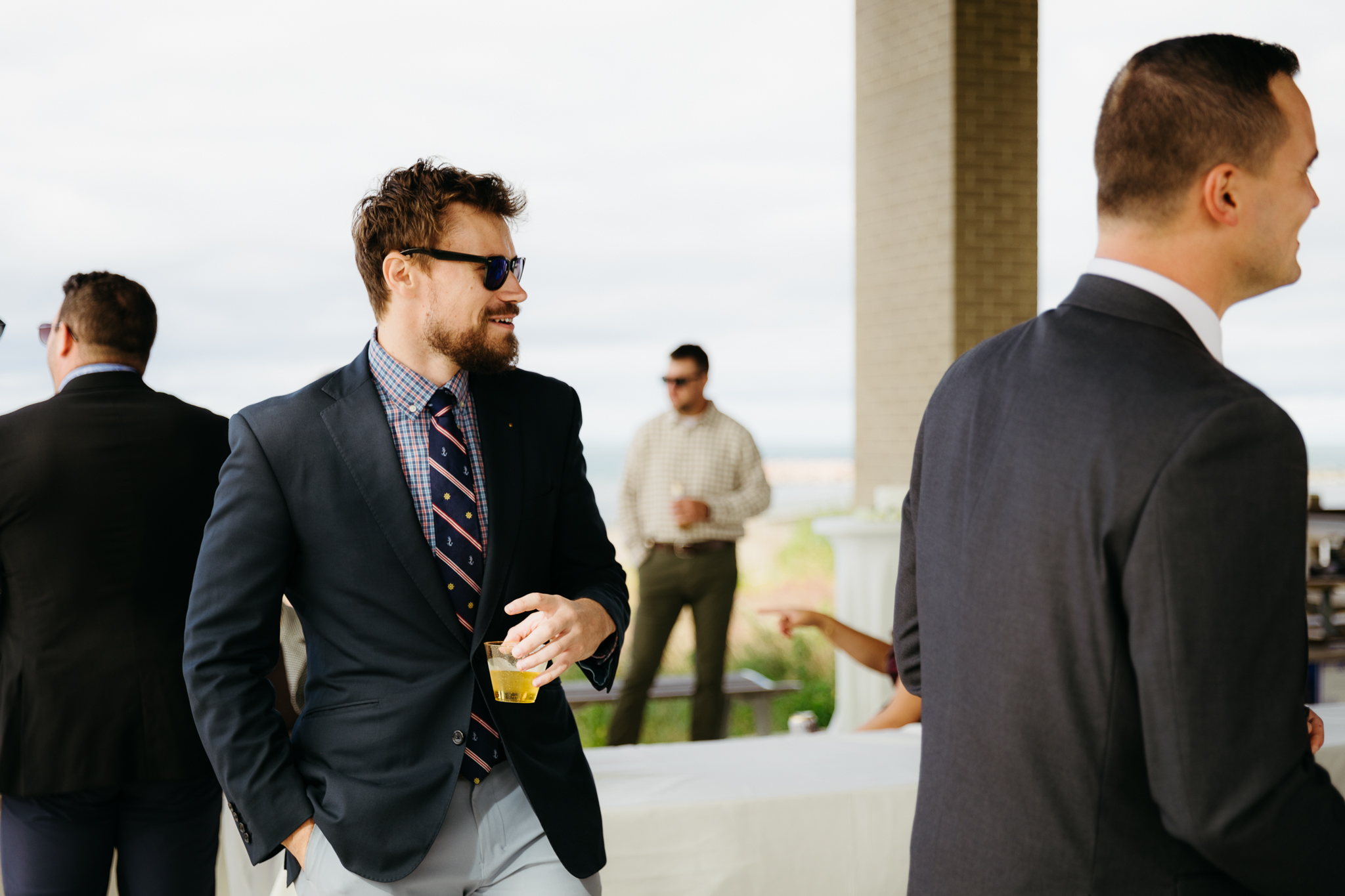 Bride and groom hanging out with family and friends during their outdoor wedding at Indiana Dunes National Park