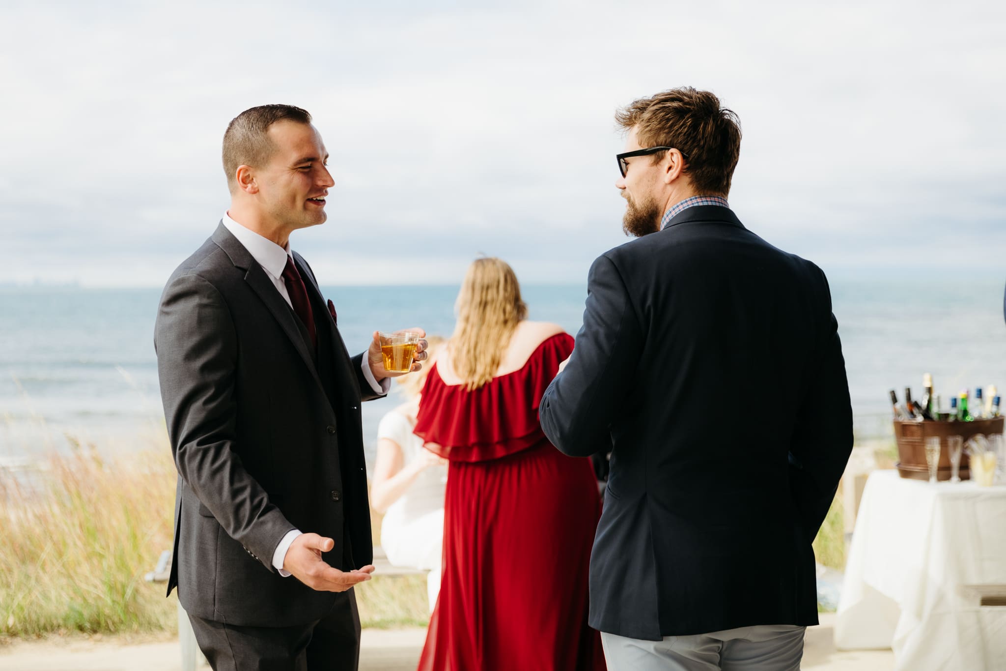 Bride and groom hanging out with family and friends during their outdoor wedding at Indiana Dunes National Park