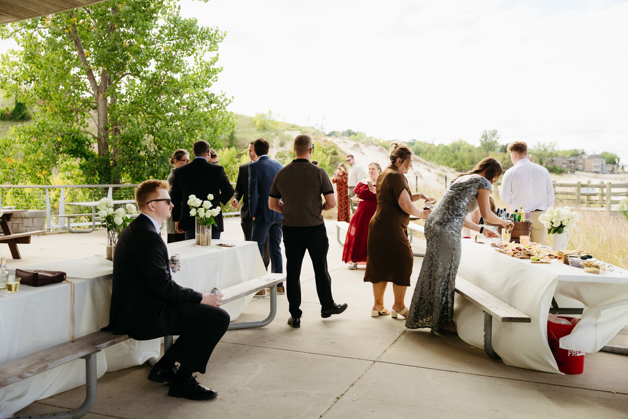 Bride and groom hanging out with family and friends during their outdoor wedding at Indiana Dunes National Park