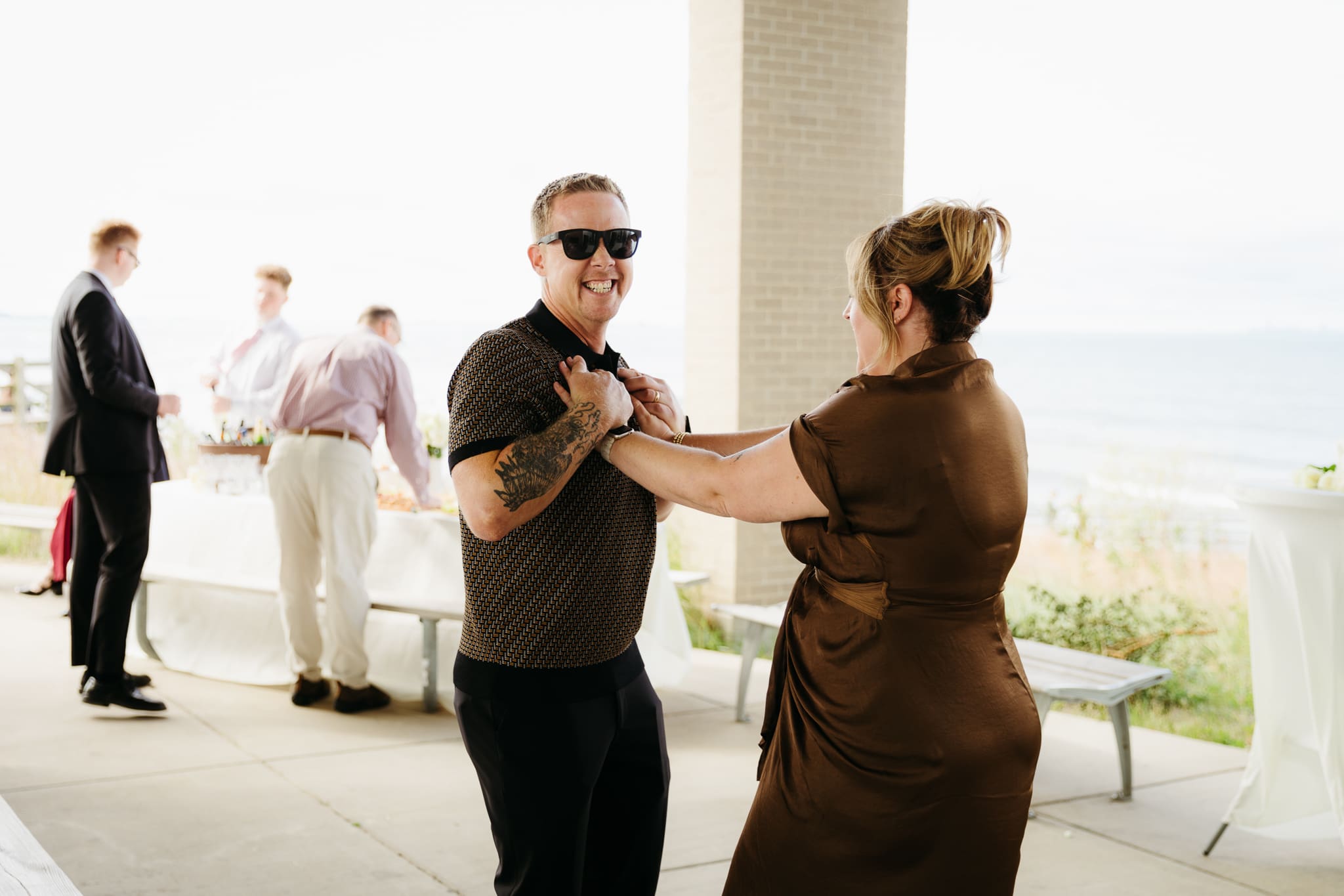Bride and groom hanging out with family and friends during their outdoor wedding at Indiana Dunes National Park