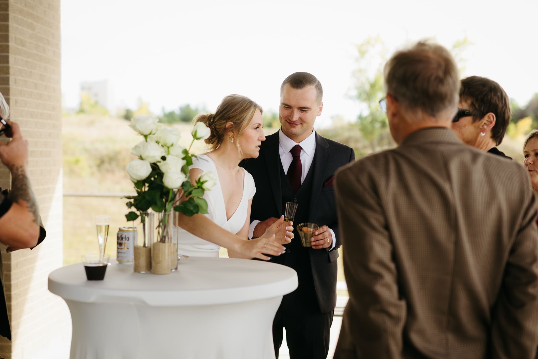 Bride and groom hanging out with family and friends during their outdoor wedding at Indiana Dunes National Park