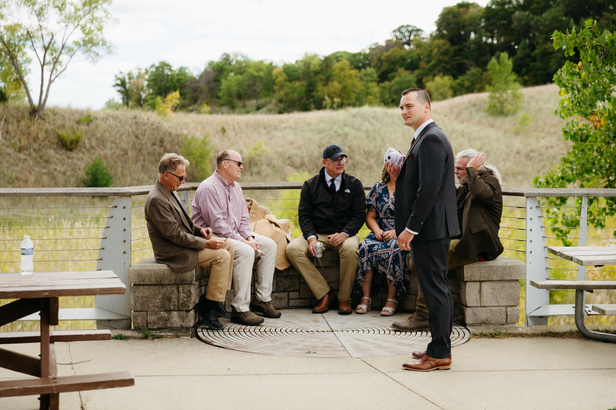 Bride and groom hanging out with family and friends during their outdoor wedding at Indiana Dunes National Park