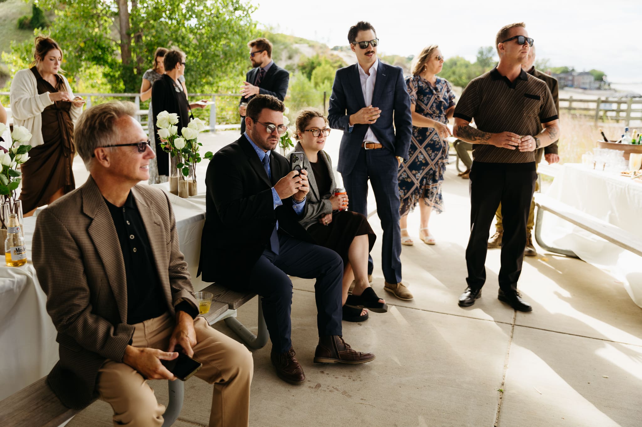 Bride and groom hanging out with family and friends during their outdoor wedding at Indiana Dunes National Park