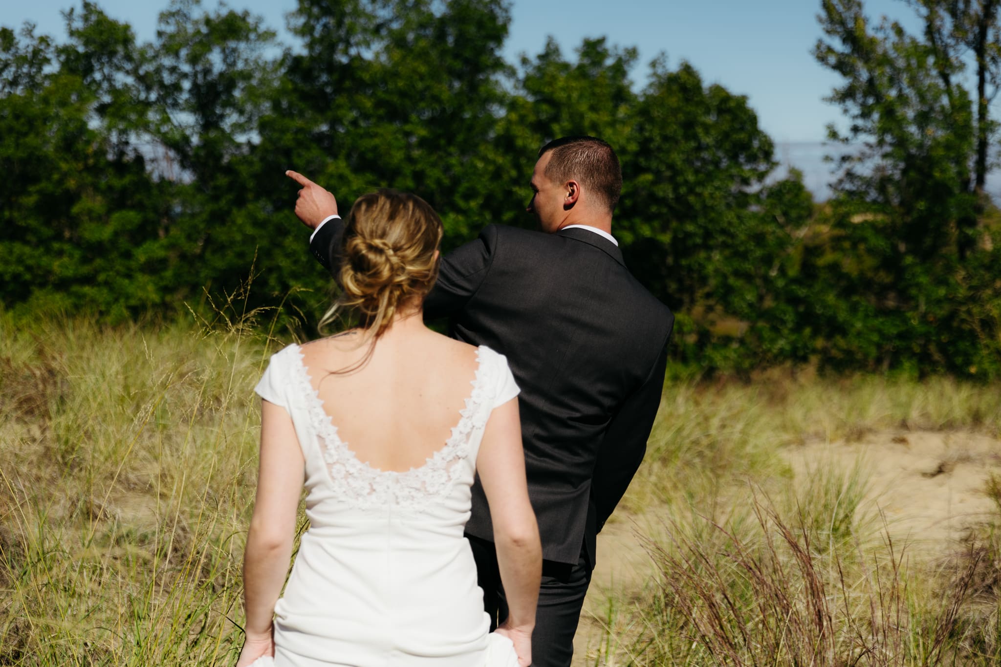 Bride and groom explore the dunes of Indiana Dunes National park during their intimate beach wedding
