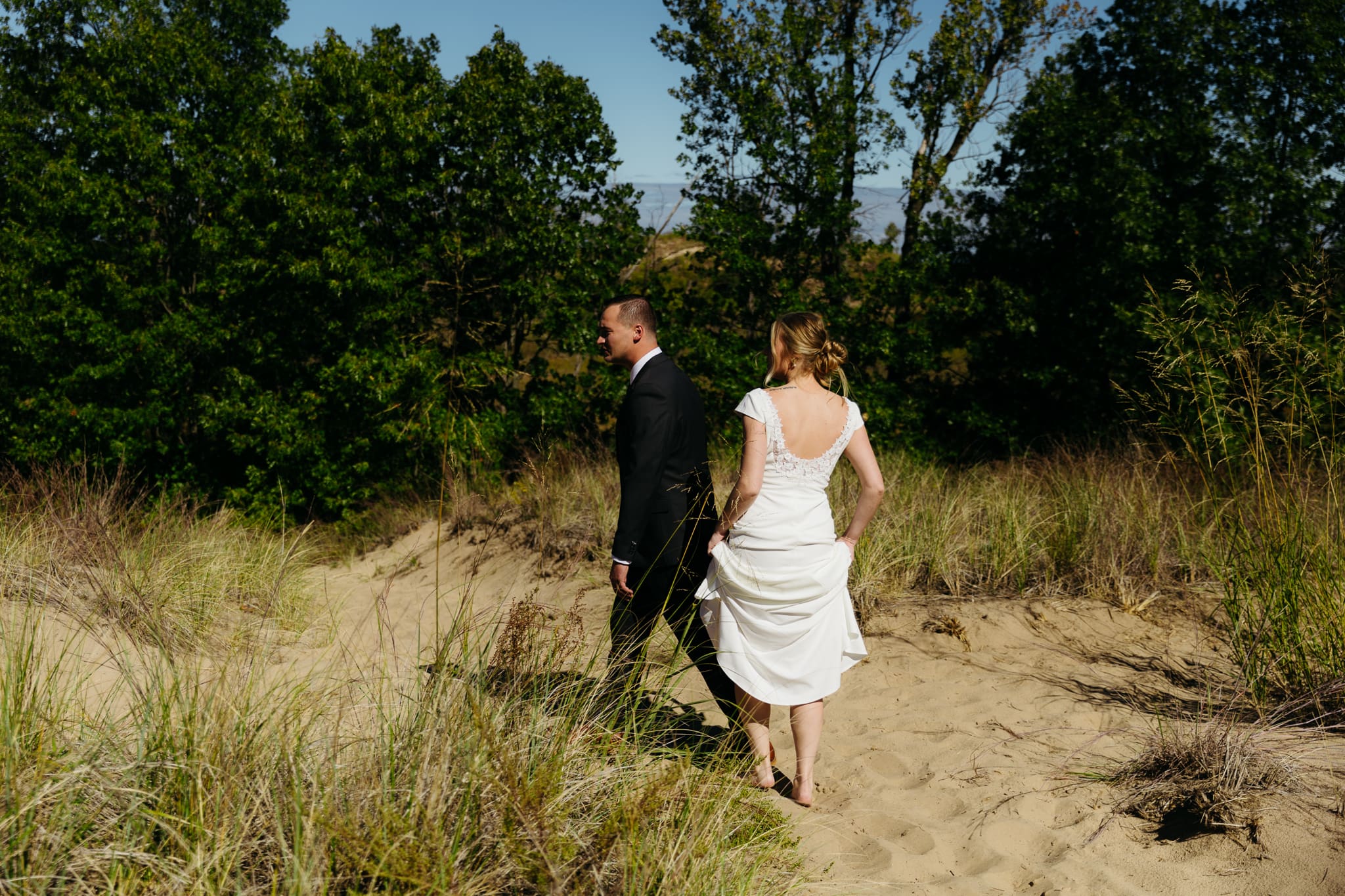 Bride and groom explore the dunes of Indiana Dunes National park during their intimate beach wedding