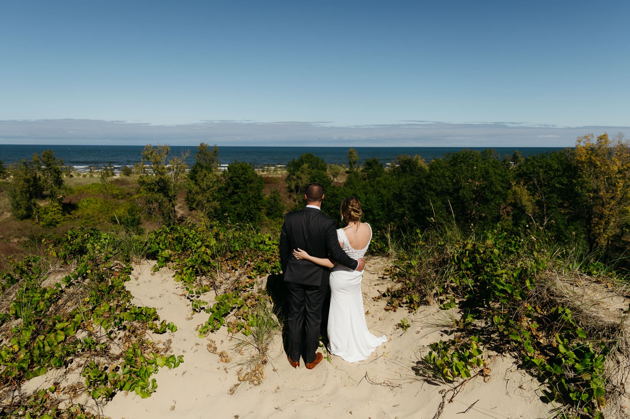 Bride and groom explore the dunes of Indiana Dunes National park during their intimate beach wedding