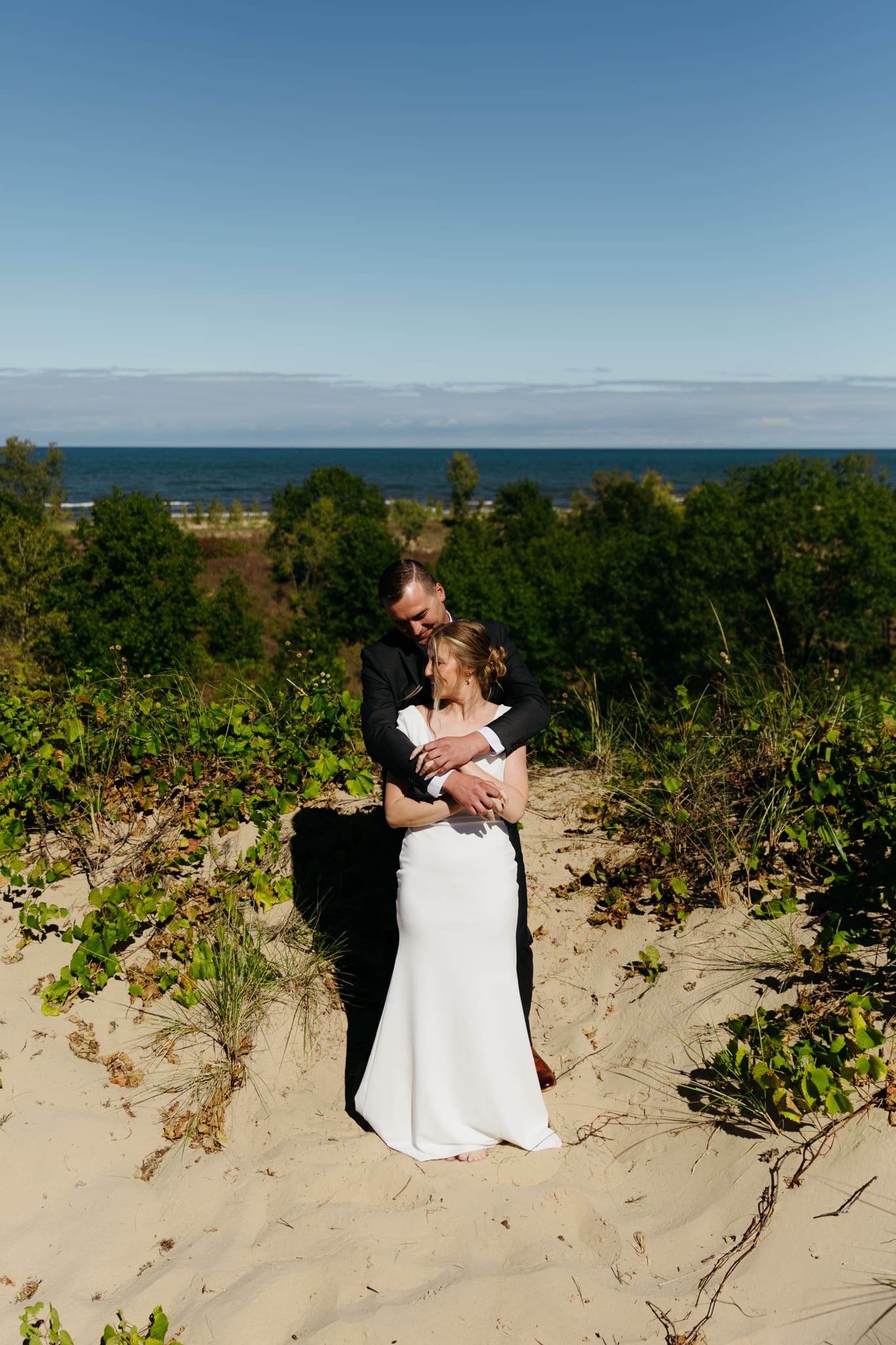 Bride and groom explore the dunes of Indiana Dunes National park during their intimate beach wedding
