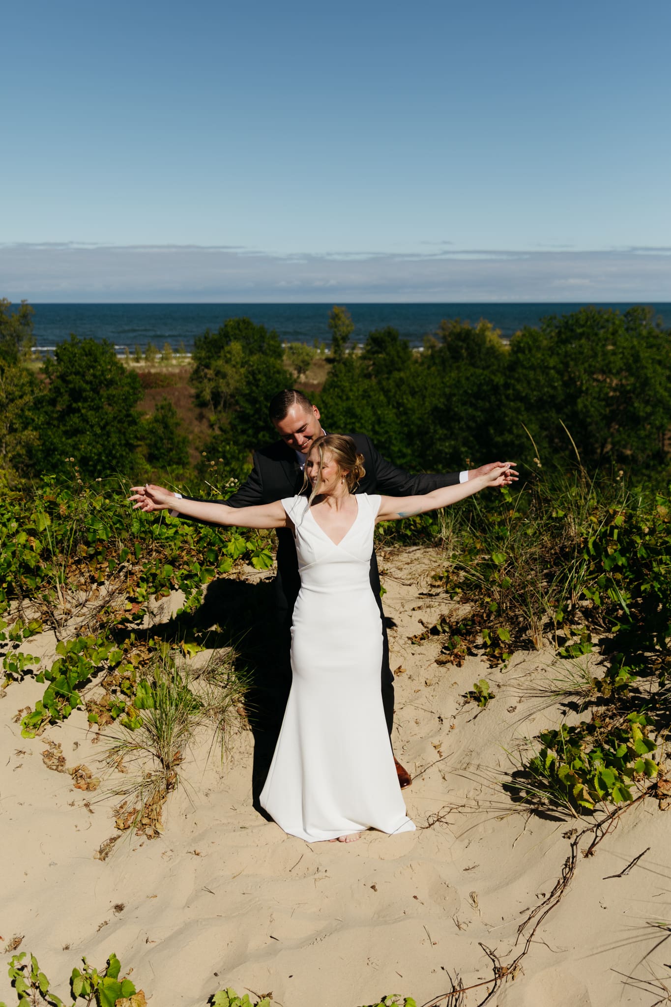 Bride and groom explore the dunes of Indiana Dunes National park during their intimate beach wedding