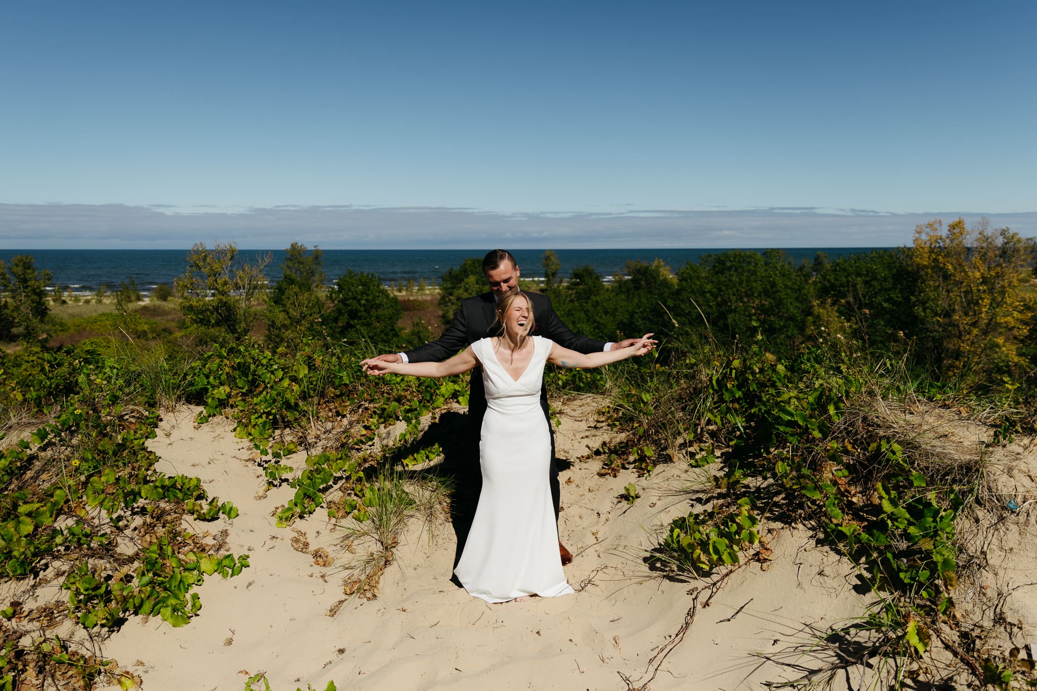 Bride and groom explore the dunes of Indiana Dunes National park during their intimate beach wedding