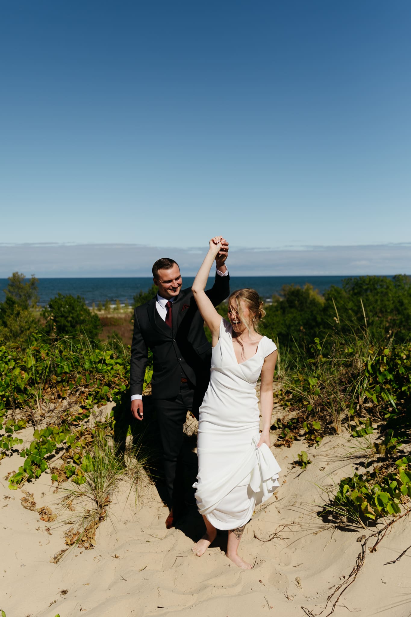 Bride and groom explore the dunes of Indiana Dunes National park during their intimate beach wedding