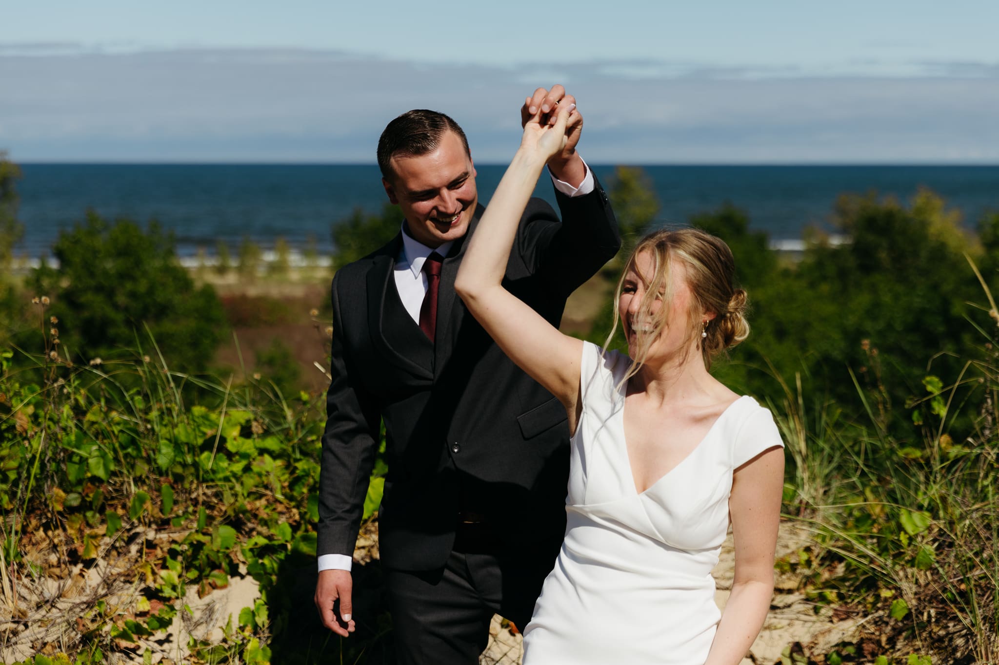 Bride and groom explore the dunes of Indiana Dunes National park during their intimate beach wedding
