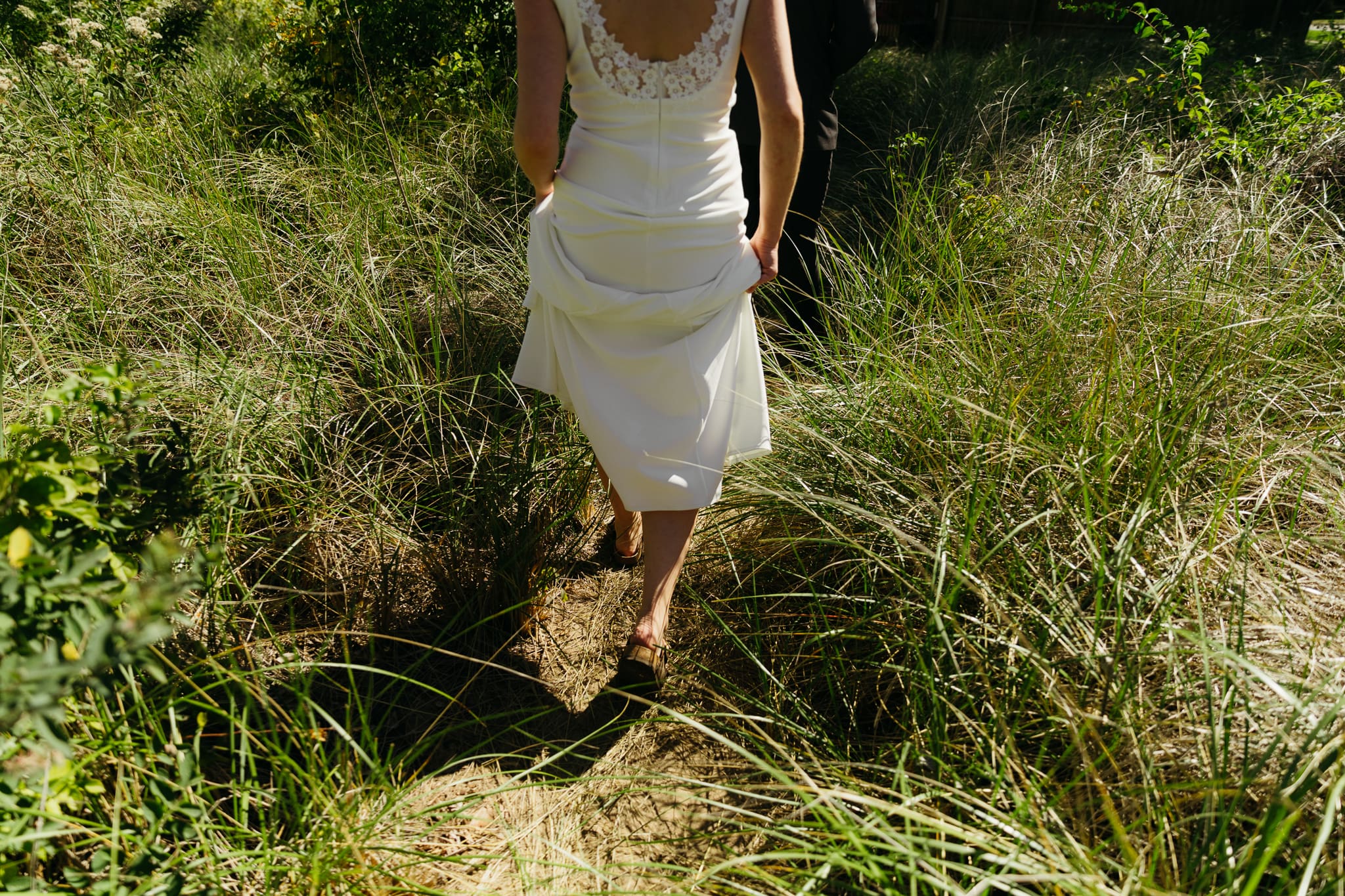 Bride and groom explore the dunes of Indiana Dunes National park during their intimate beach wedding